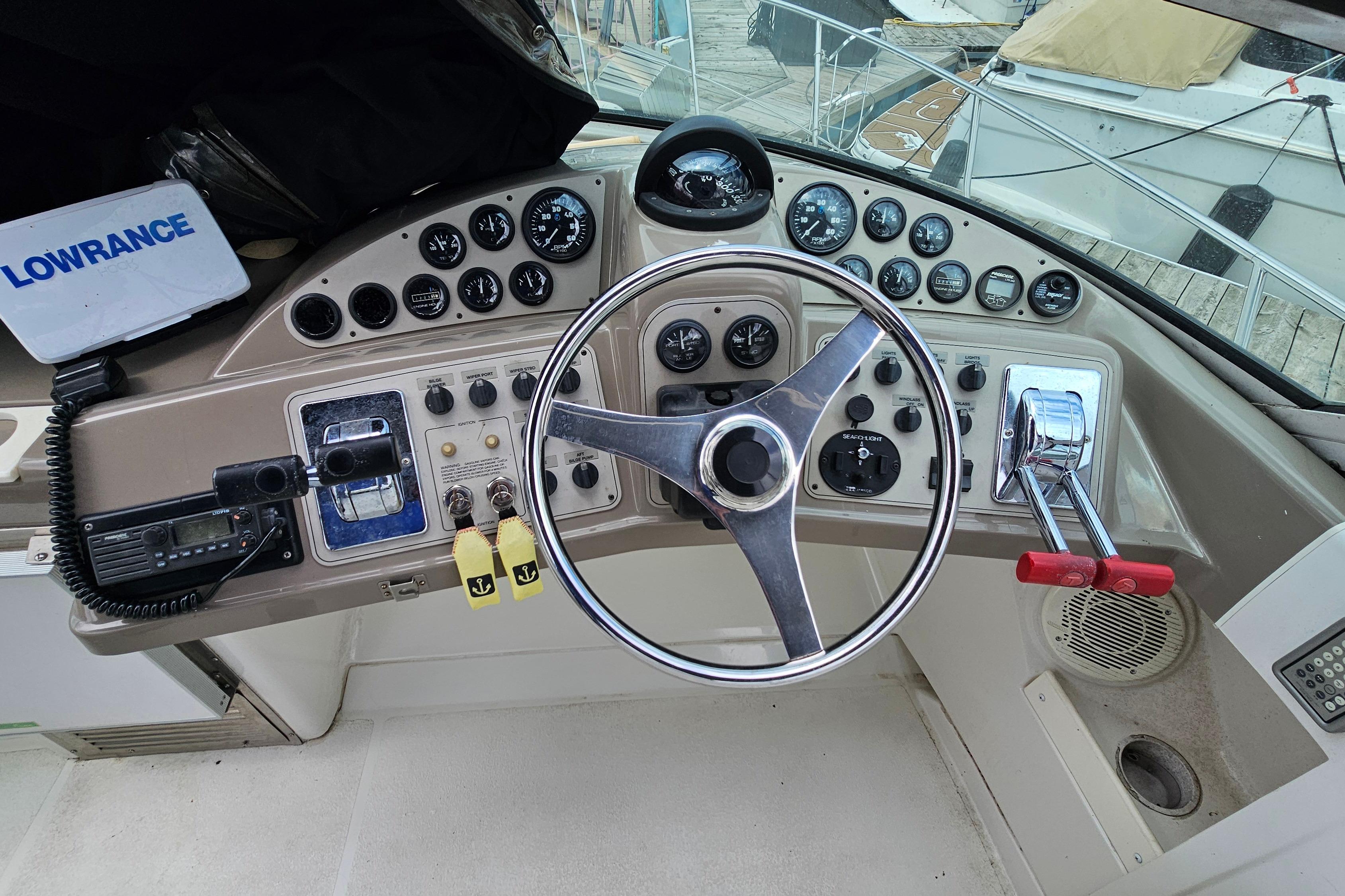 1999 Carver 350 Mariner helm with steering wheel, gauges, and controls.