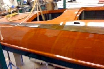 1931 Hacker-Craft 26 Dolphin boat with polished wooden finish in workshop setting.