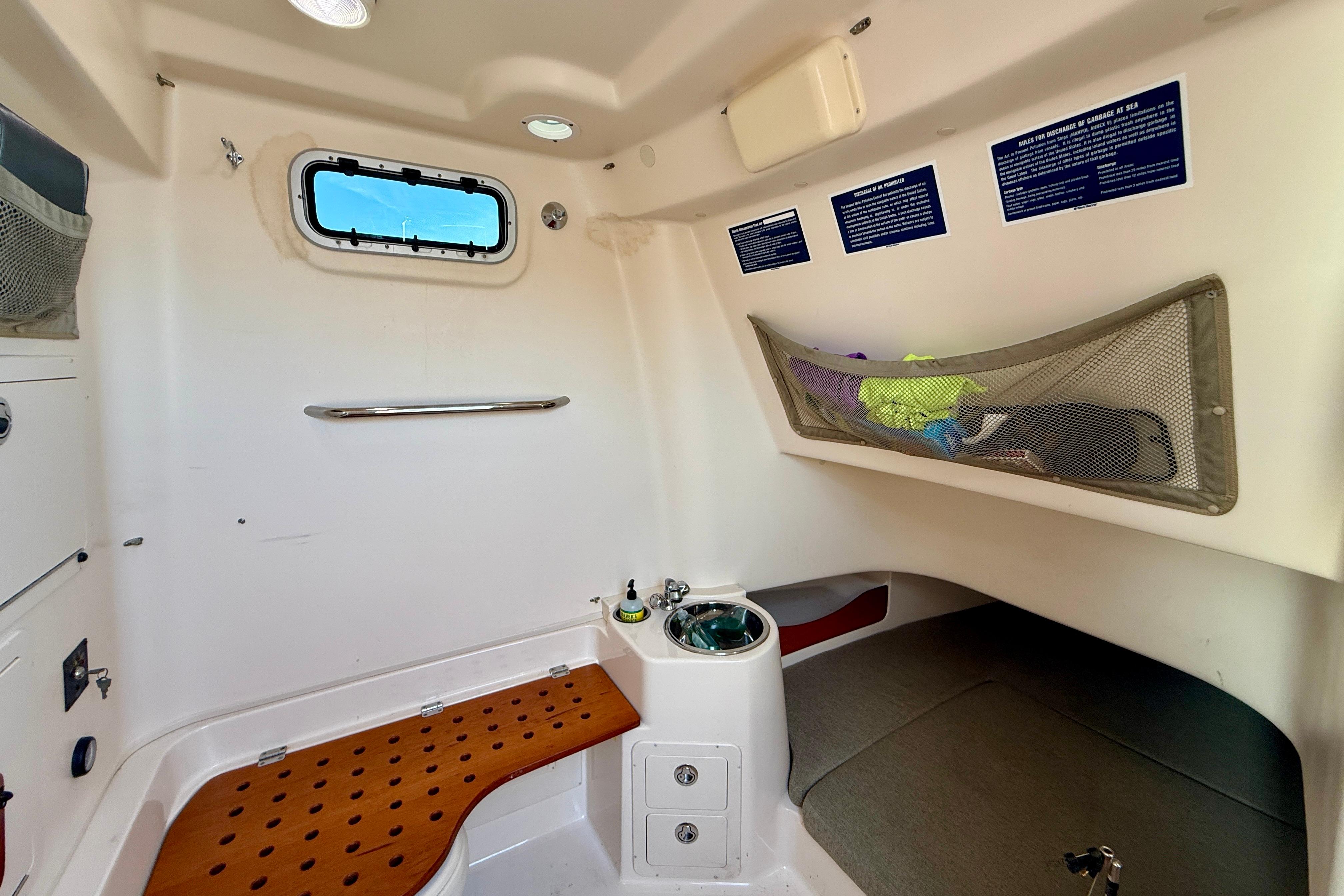 Interior cabin of 2012 Grady-White Canyon 336 boat with storage and seating.
