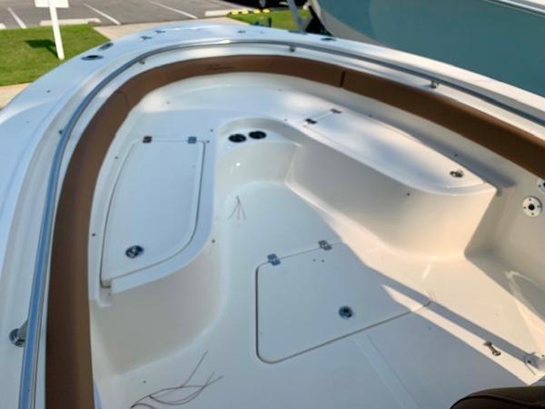 2025 Pioneer 222 Islander boat interior with seating and storage compartments.
