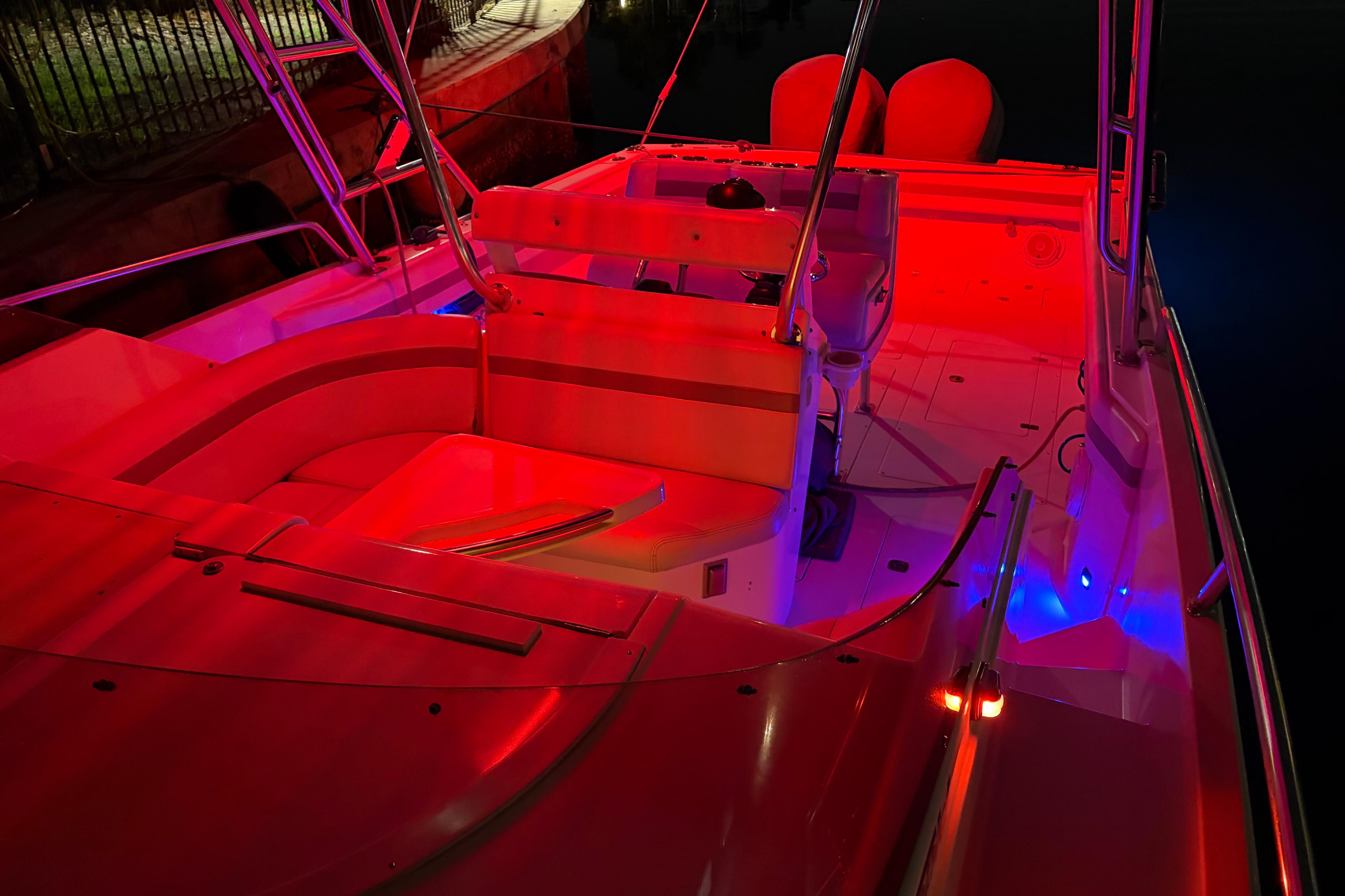 1998 Intrepid 339 Walkaround boat interior illuminated with vibrant red and blue lights.