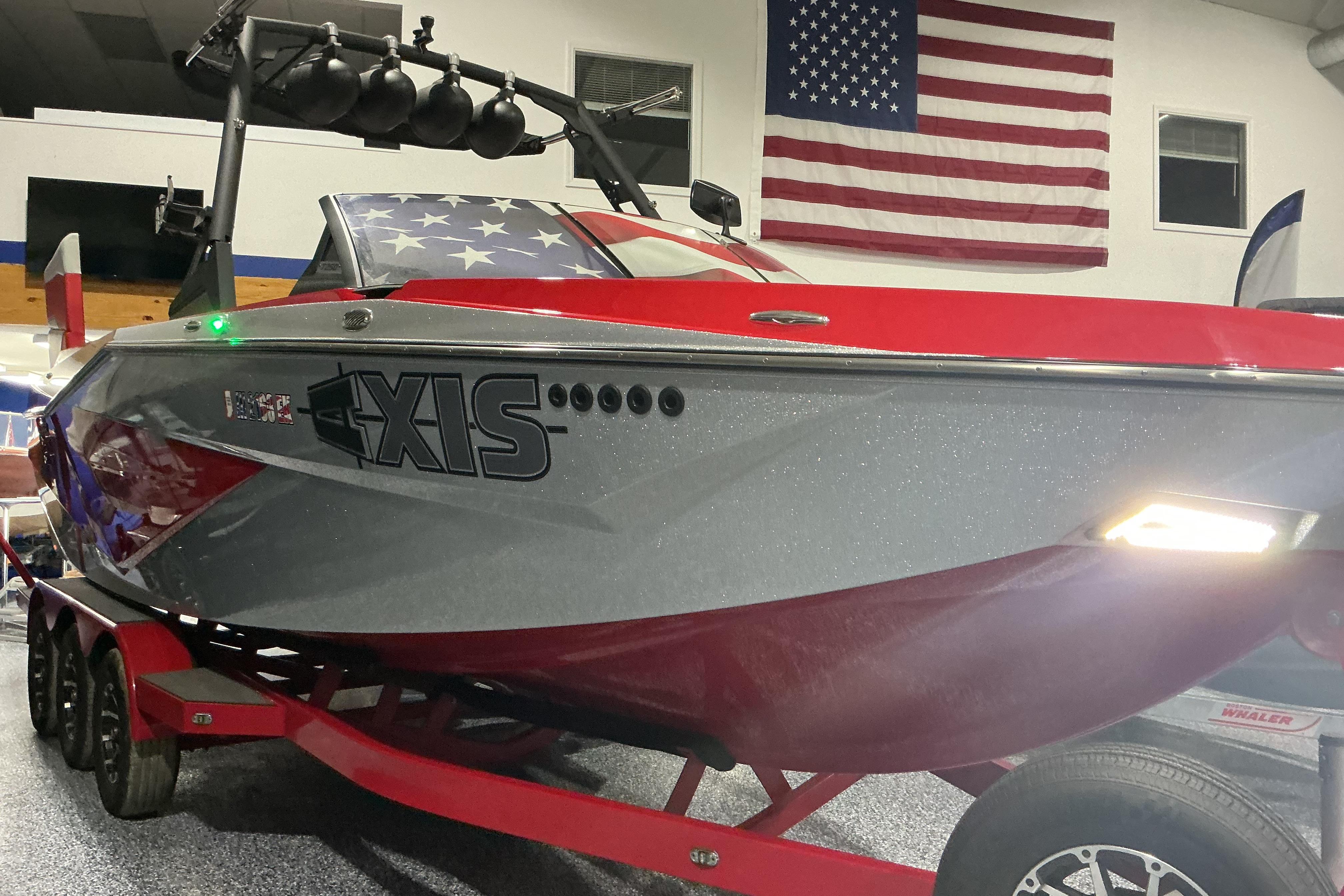 2022 Axis T250 boat in showroom with American flag backdrop.