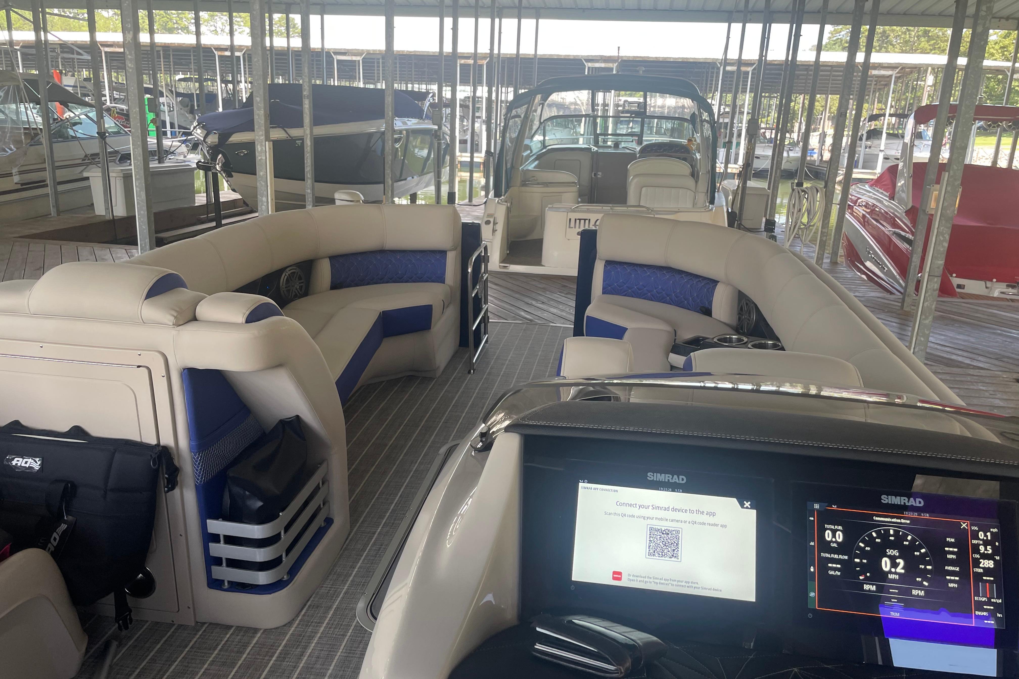 2022 Harris Grand Mariner 250 pontoon boat interior with modern dashboard and seating.