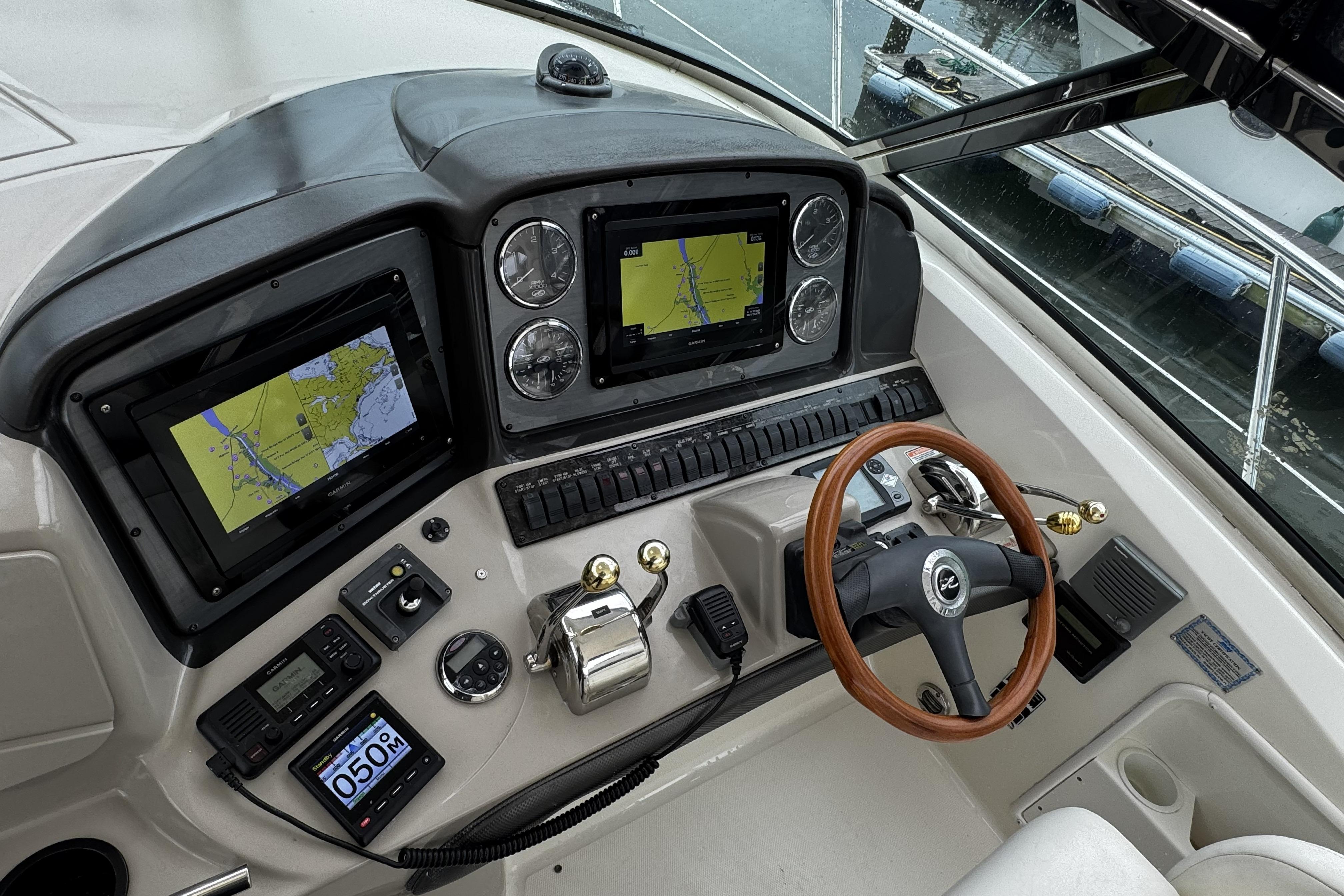 Helm of 2006 Sea Ray 40 Sundancer with navigation screens and controls.