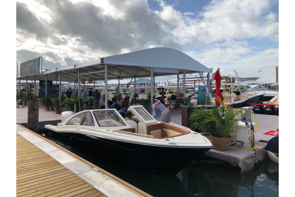 2023 Scout 240 Dorado boat docked at marina under cloudy sky.
