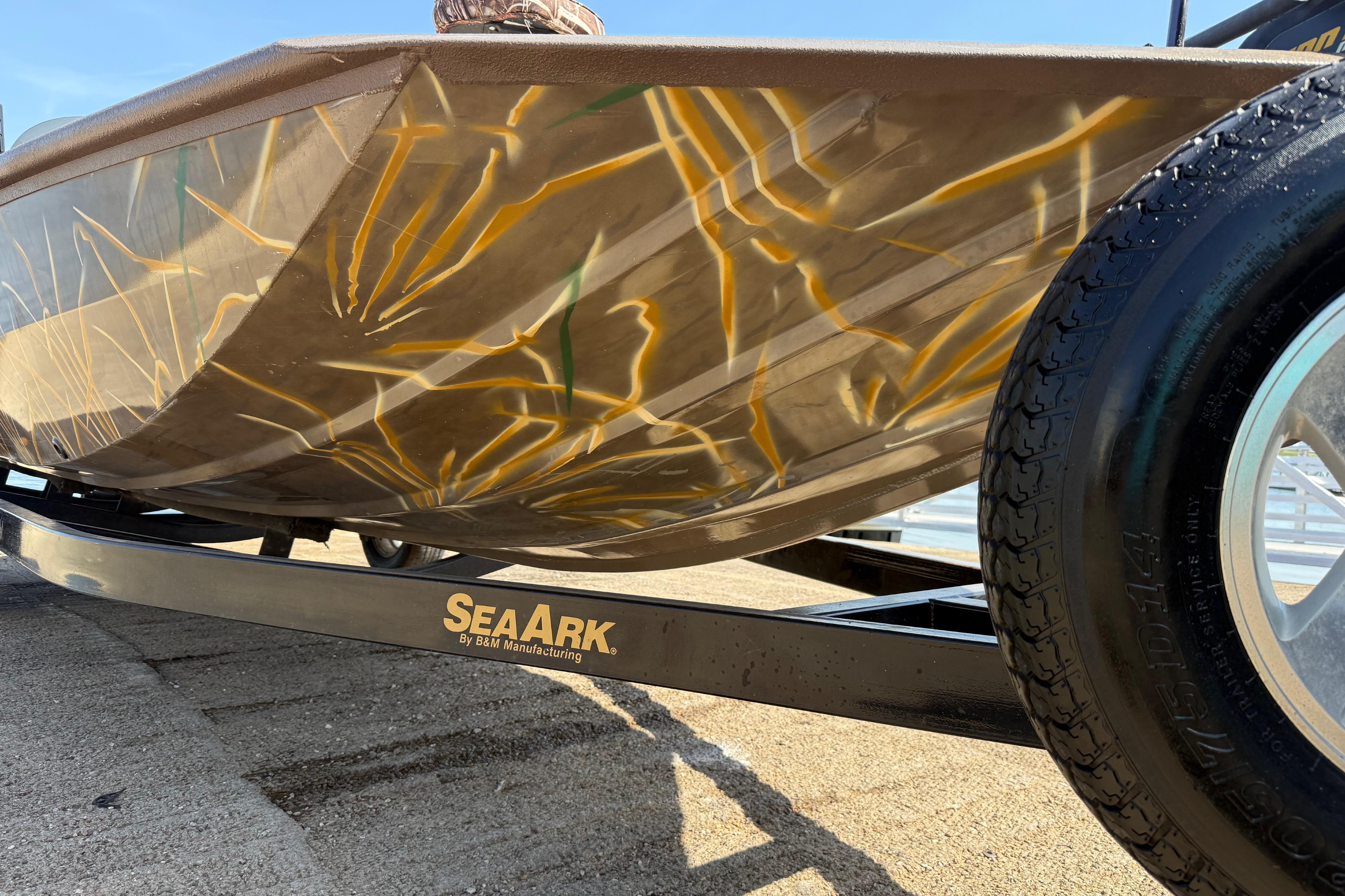 2010 SeaArk Stealth 190 boat with camouflage design on a trailer.