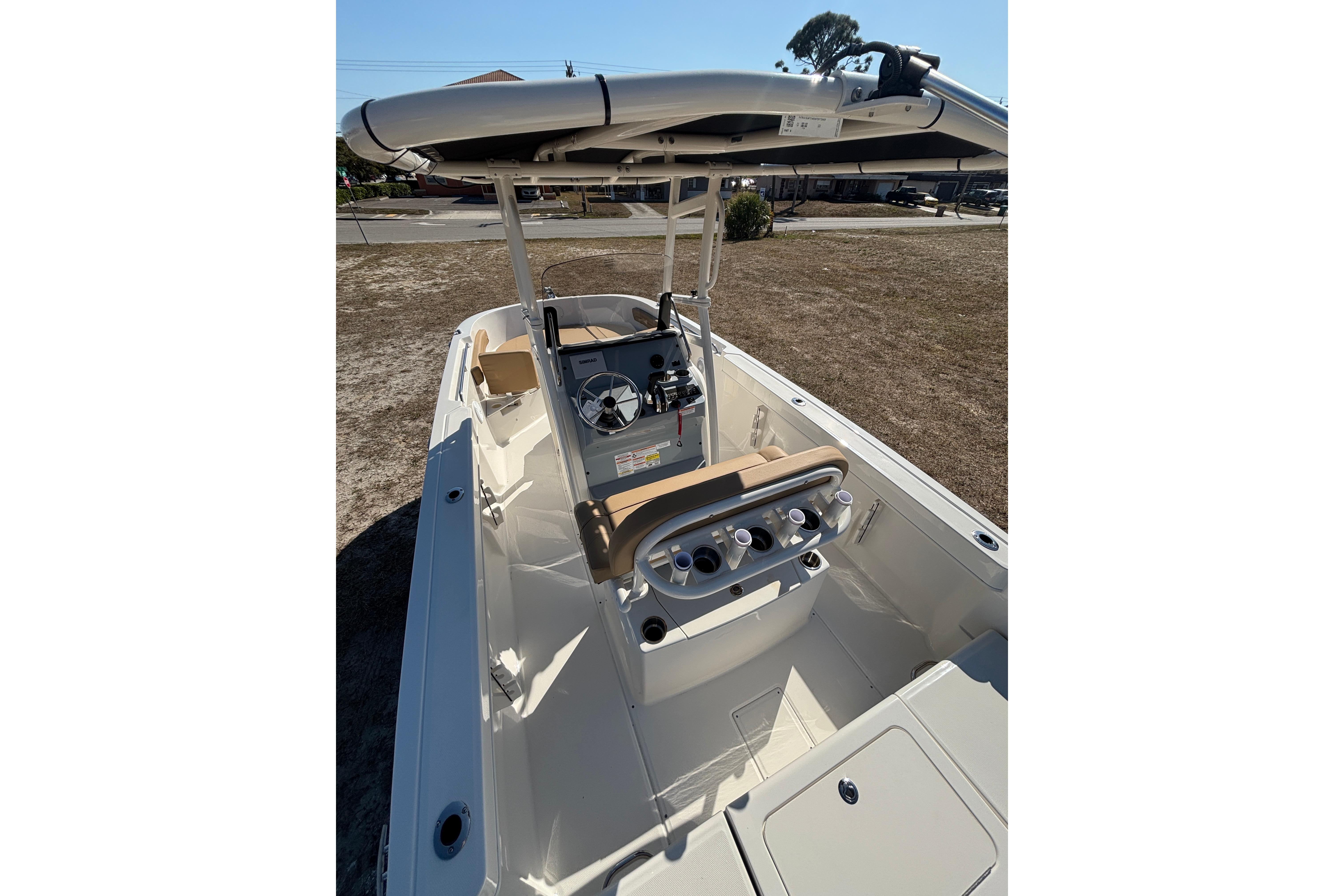 2026 Bayliner Trophy T22CC boat interior with helm, seating, and rod holders.