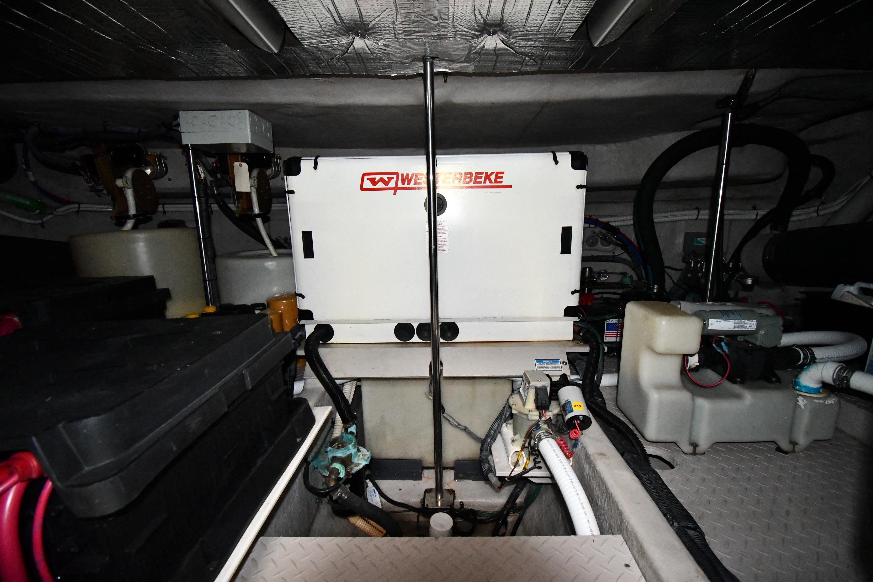 Engine room of 2001 Sea Ray 540 Sundancer with Westerbeke generator and various mechanical components.