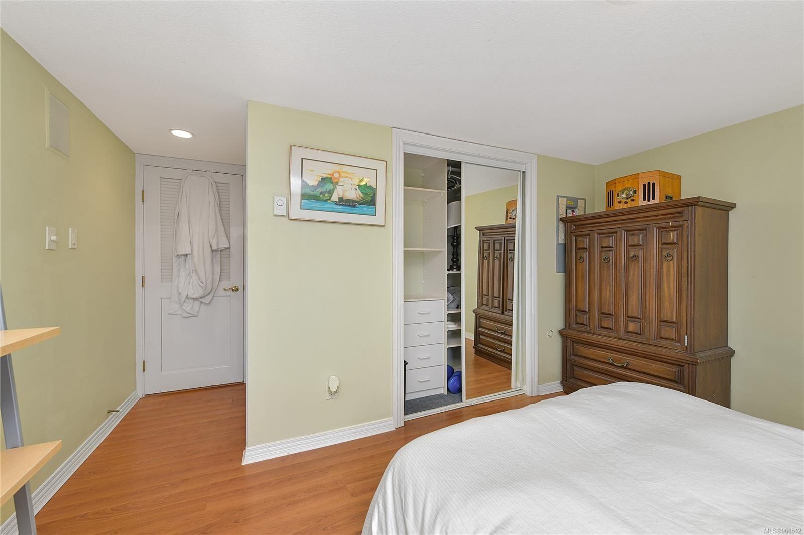 Bedroom in a 2005 custom float home with wooden furniture and closet.