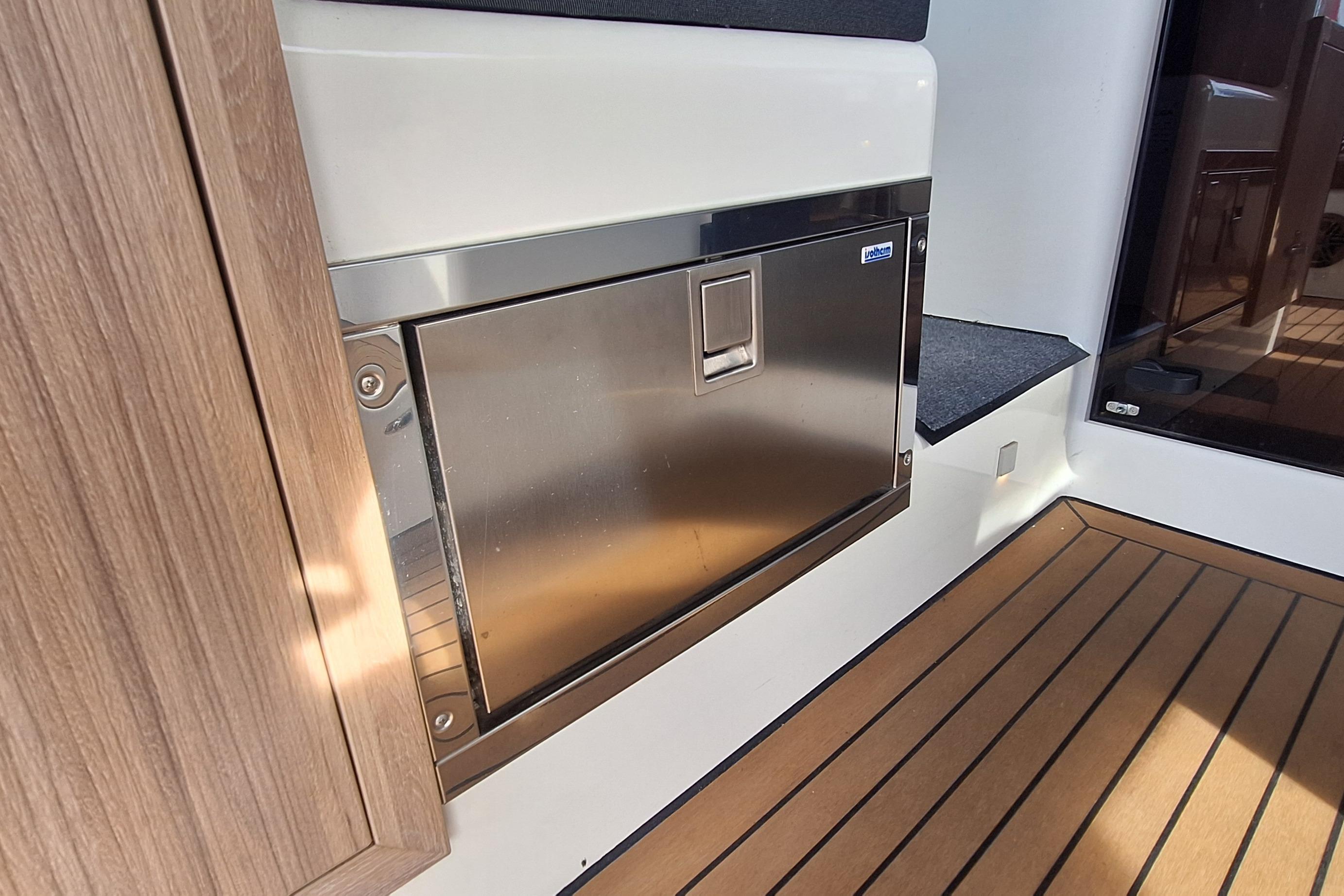 Stainless steel compartment on 2023 Antaris X boat with wooden flooring.