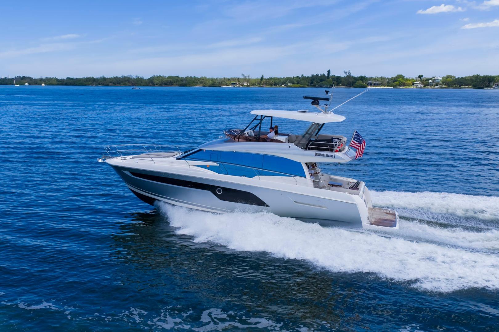 2022 Prestige 520 yacht cruising on blue waters under a clear sky.