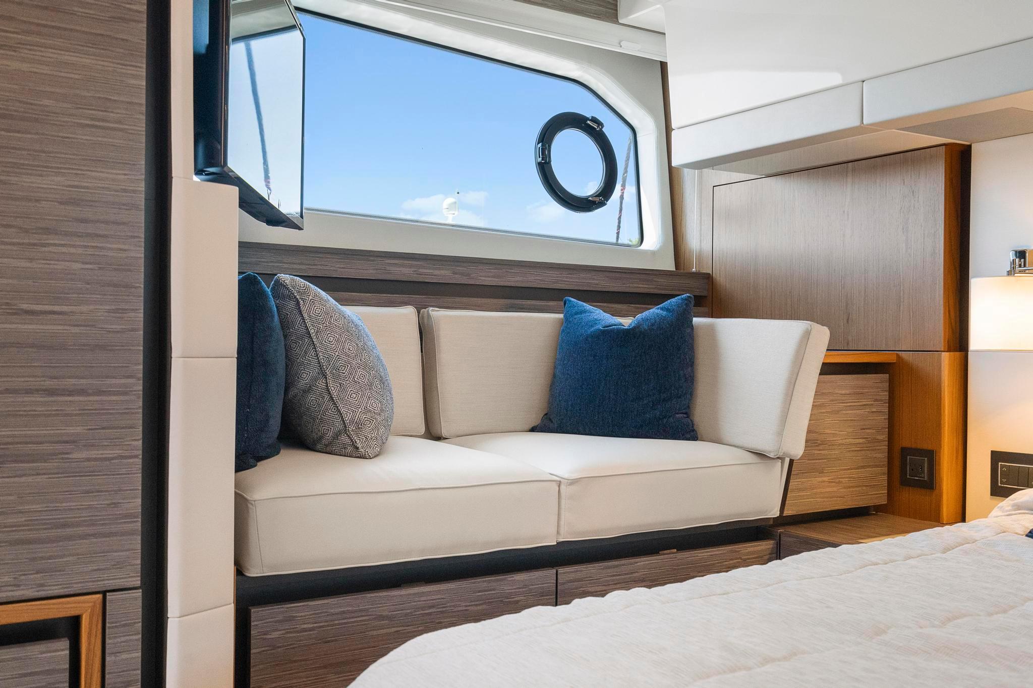 Luxurious interior of 2022 Tiara Yachts C49 Coupe with elegant seating and window view.