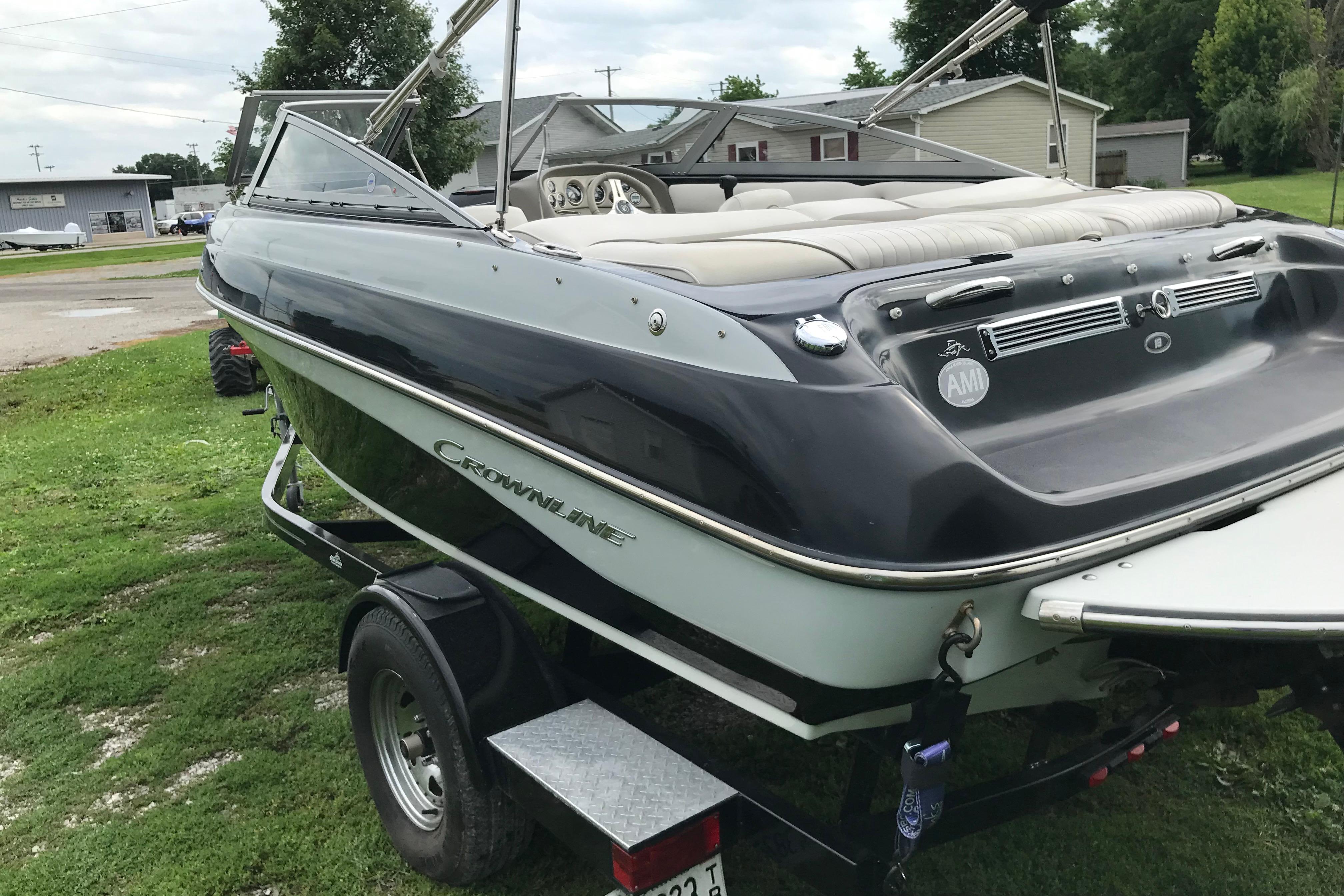 2015 Crownline 18 SS boat on trailer, parked on grass.