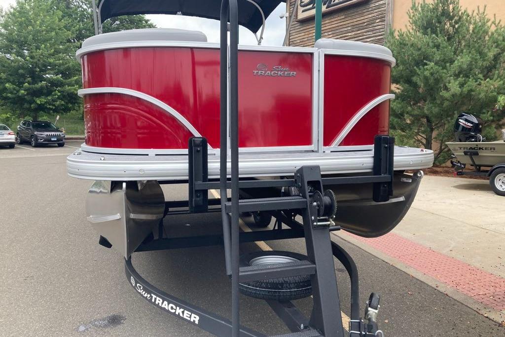 2026 Sun Tracker Party Barge 20 DLX pontoon boat on trailer, red exterior.