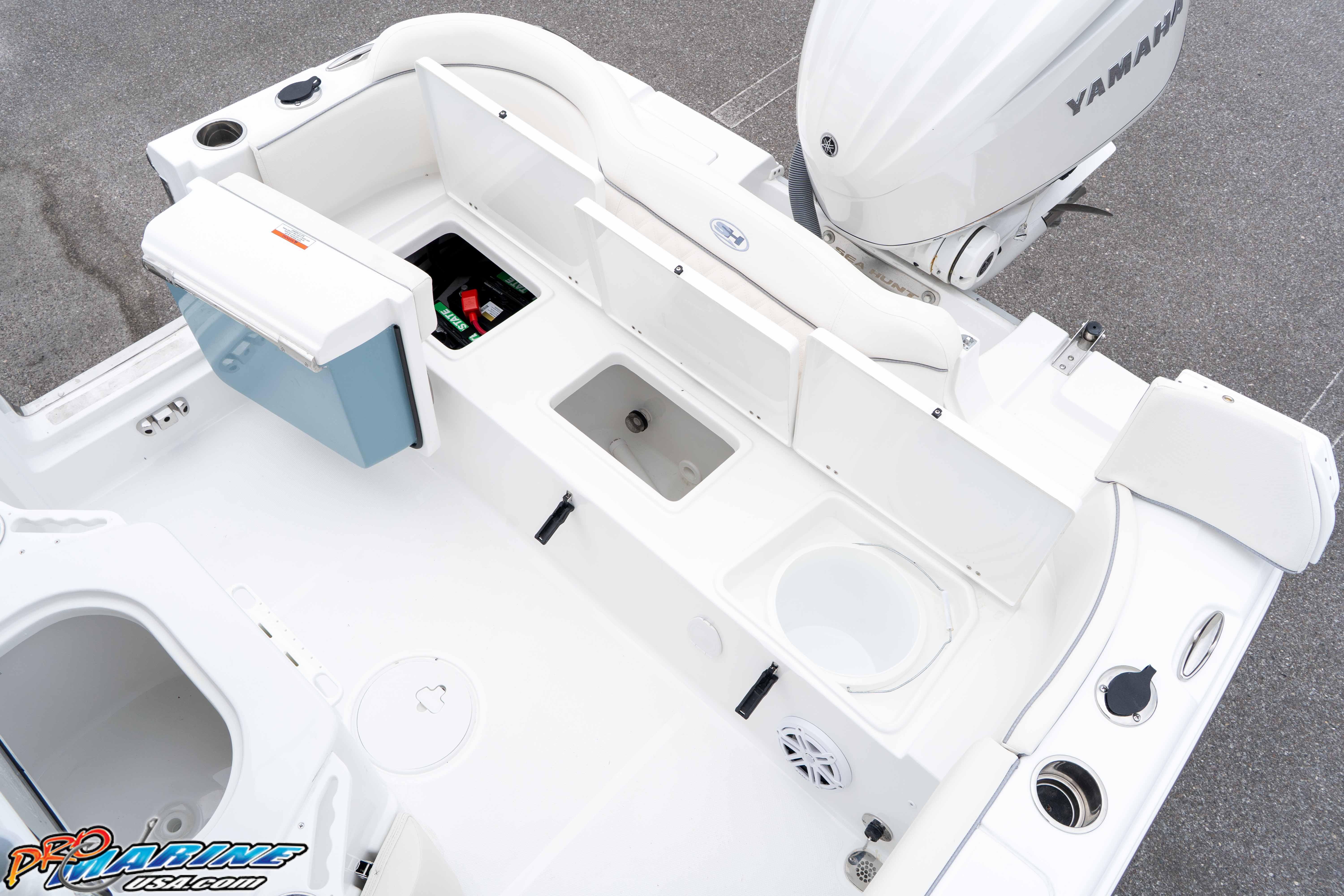 2026 Sea Hunt Ultra 245 SE boat interior with Yamaha engine, featuring storage and seating.