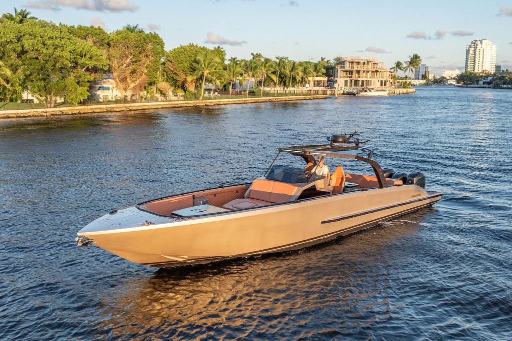 2023 DeKoning 43 luxury yacht cruising on a scenic waterway.