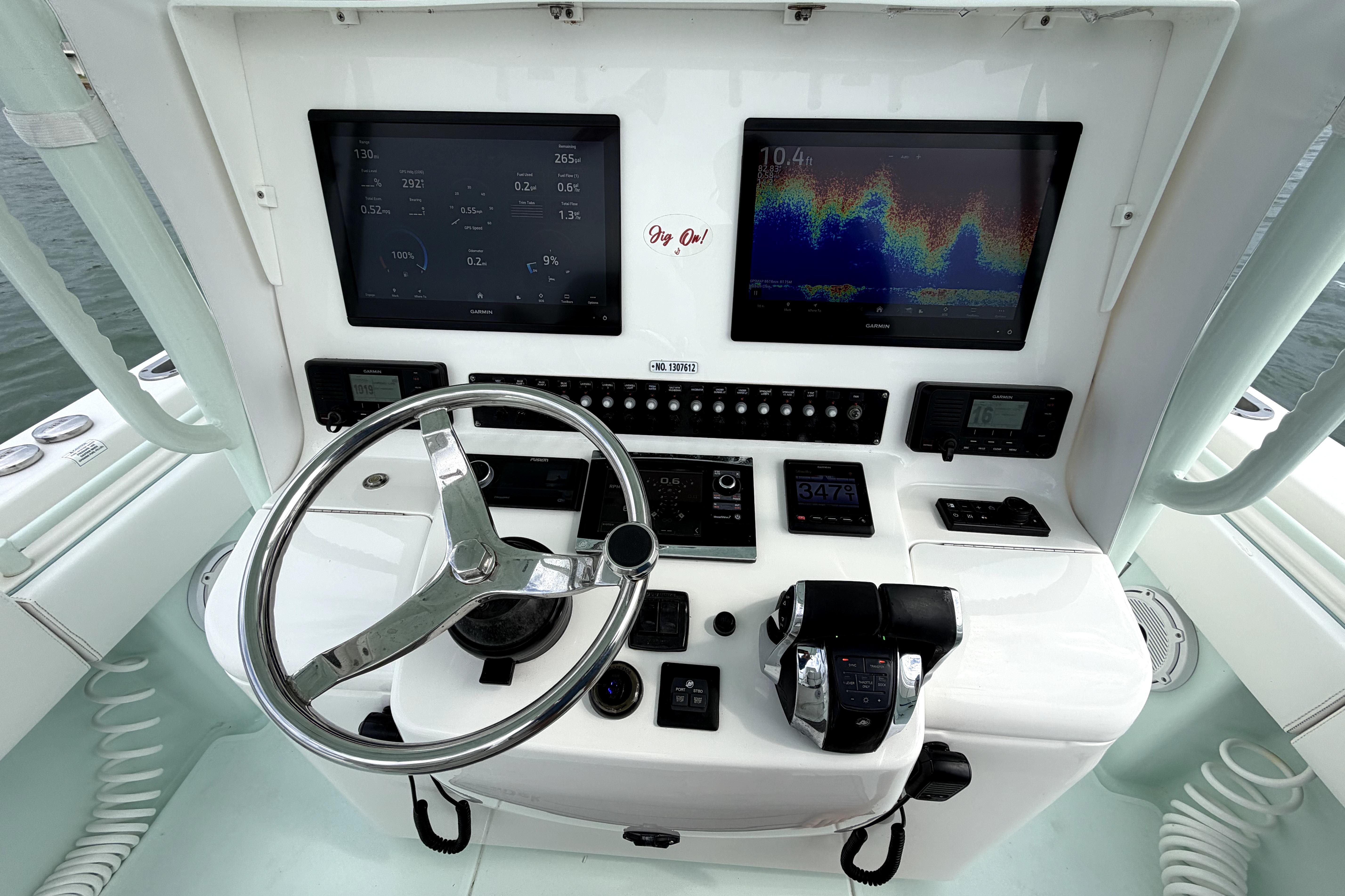 2019 Contender 30 ST boat dashboard with dual screens and steering wheel.