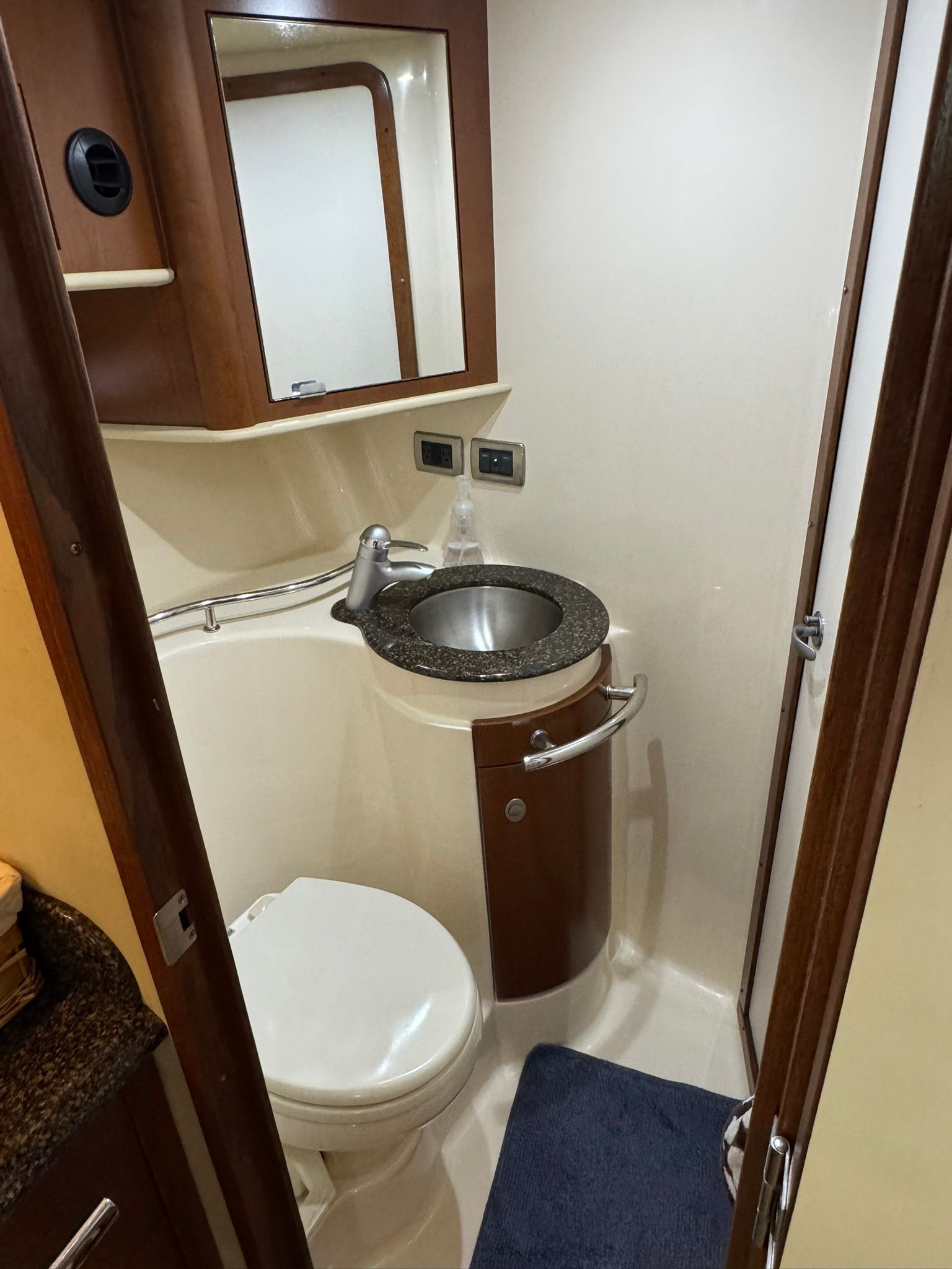 Bathroom in a 2007 Sea Ray 40 Sundancer with sink, toilet, and mirror.