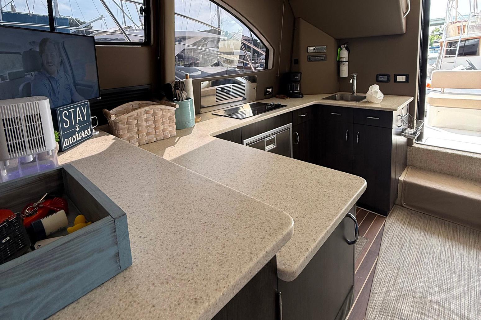 Interior of 2013 Carver C34 yacht featuring modern kitchen and entertainment area.