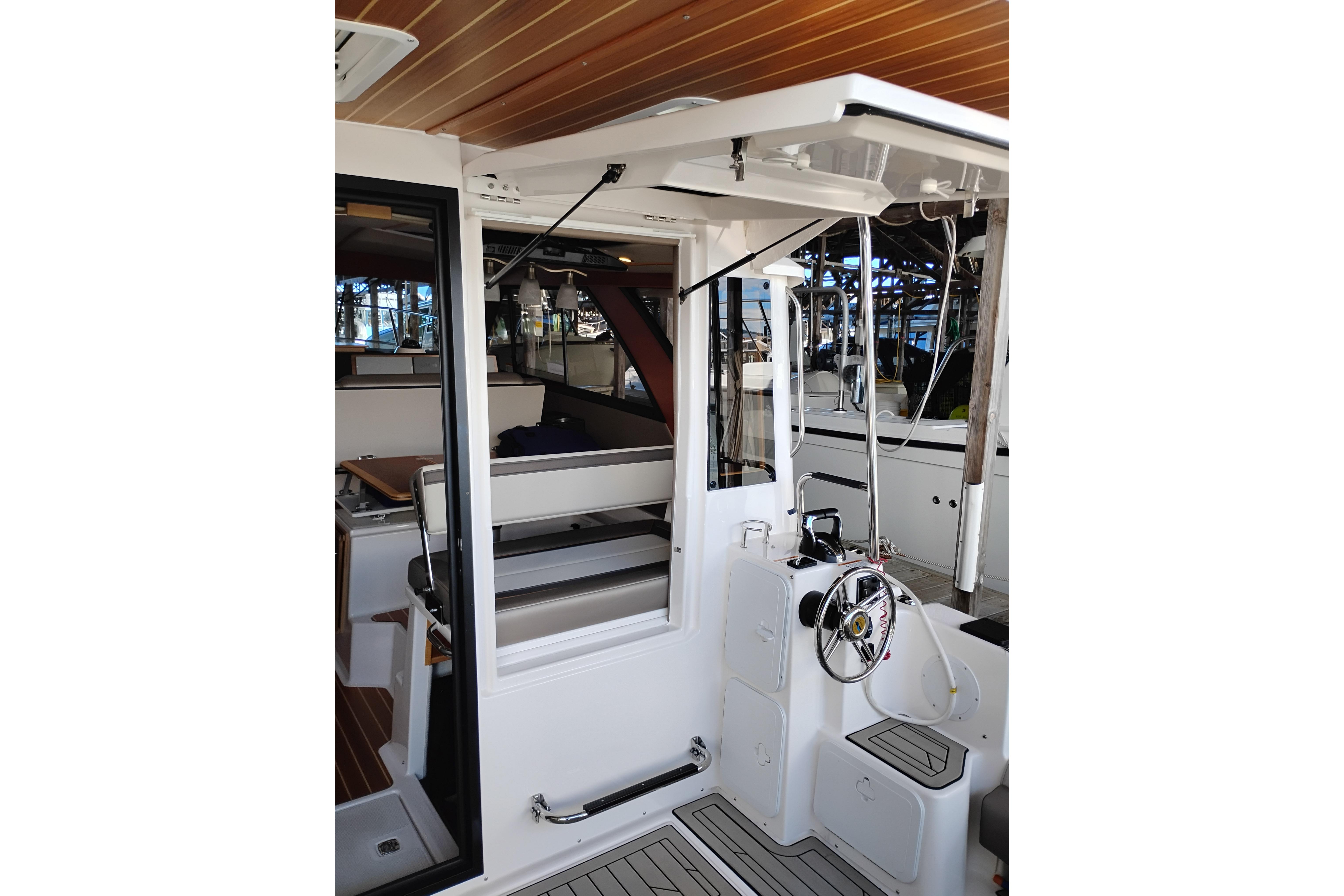 2022 Cutwater C-32 Coupe interior with helm station and seating area.