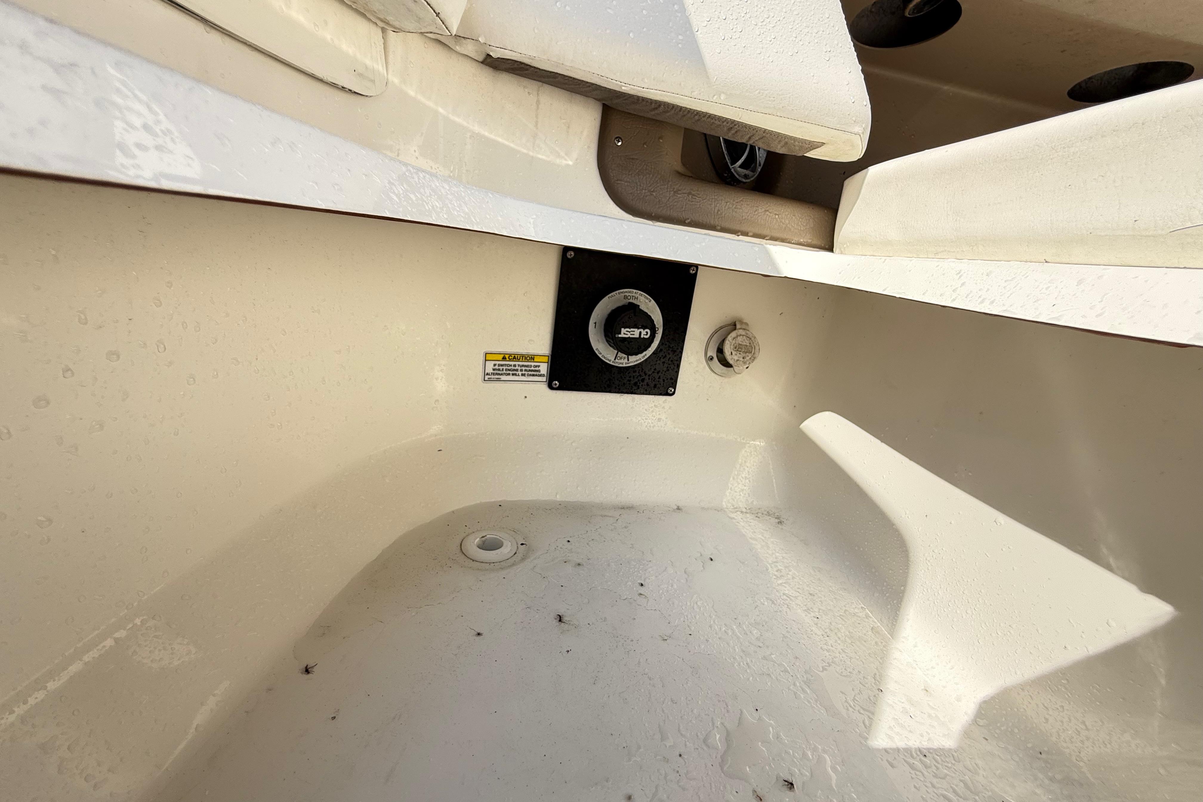 Interior view of a 2011 Sea Ray 270 SLX boat, showing seating and storage area.
