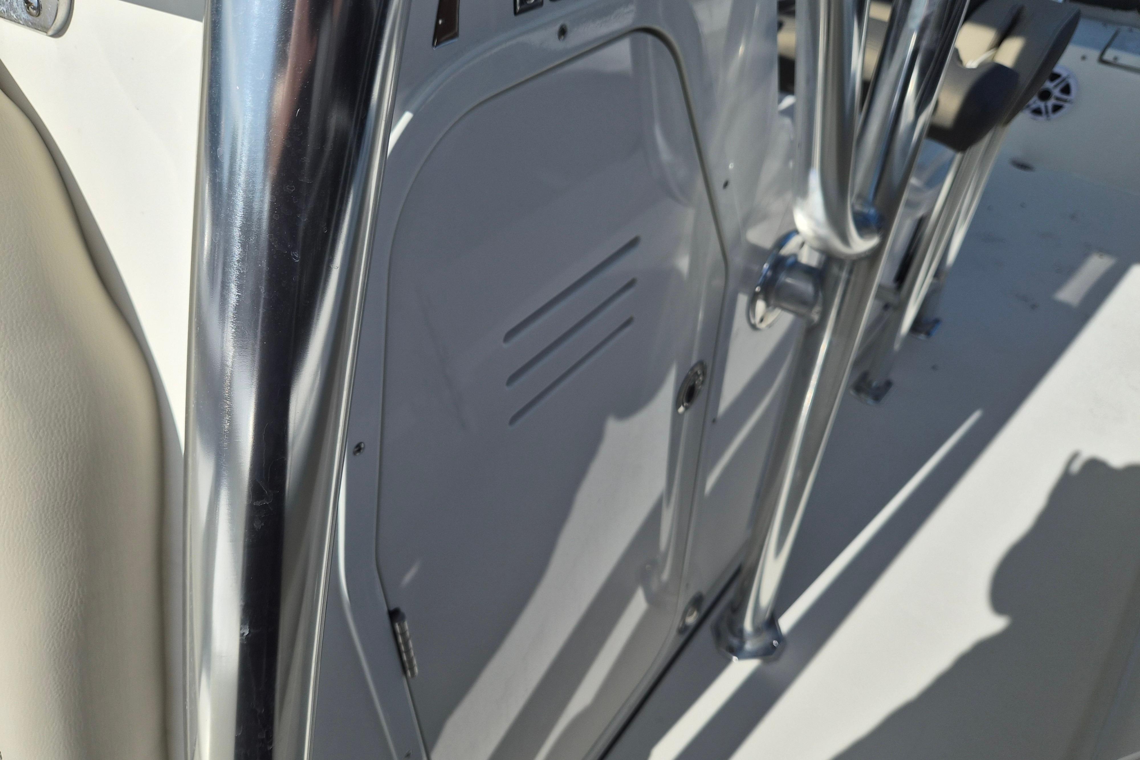 2026 Key West 239 FS boat interior with stainless steel railing and storage compartment.