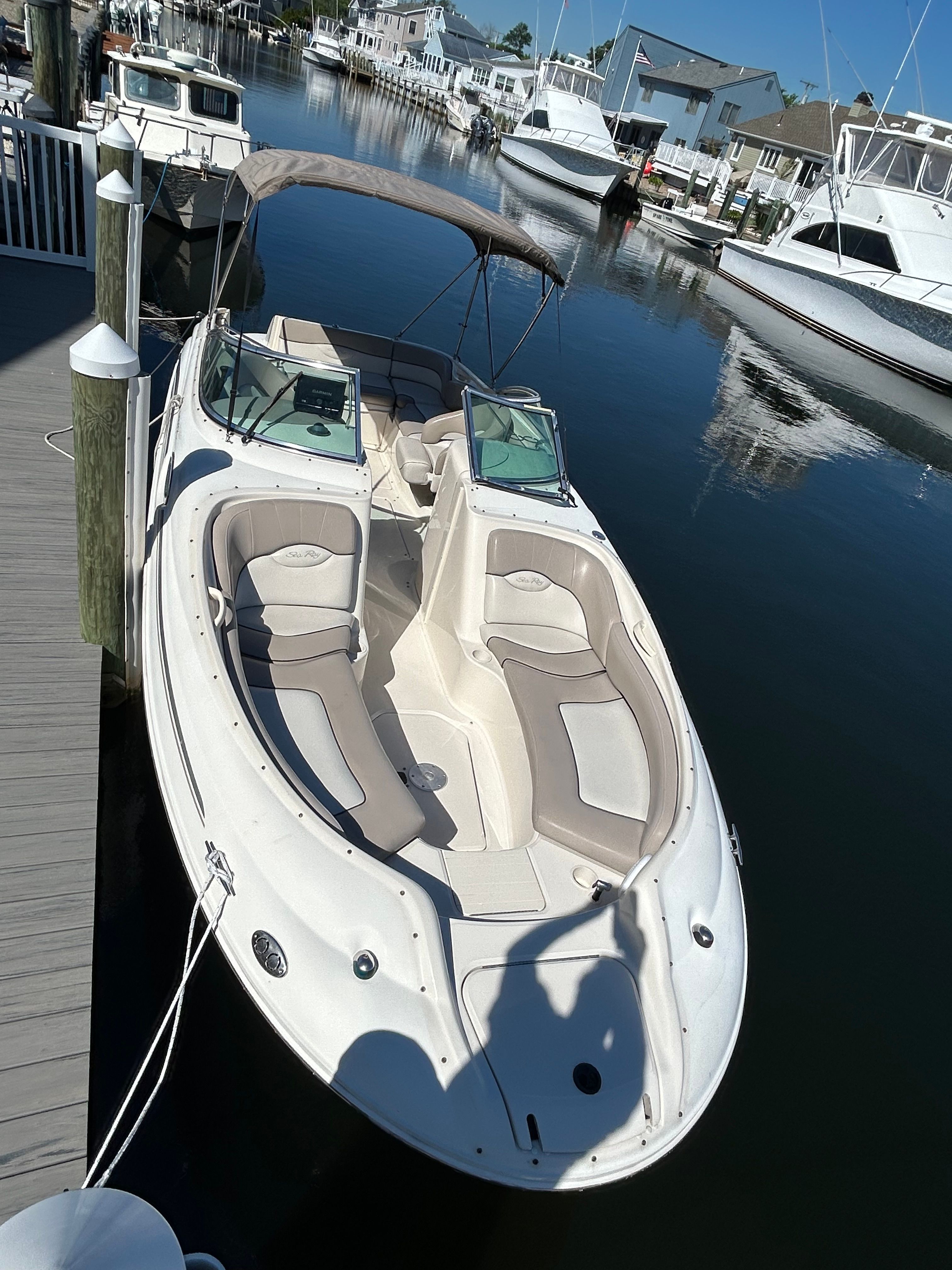 2003 Sea Ray 240 Sundeck docked in calm waters.