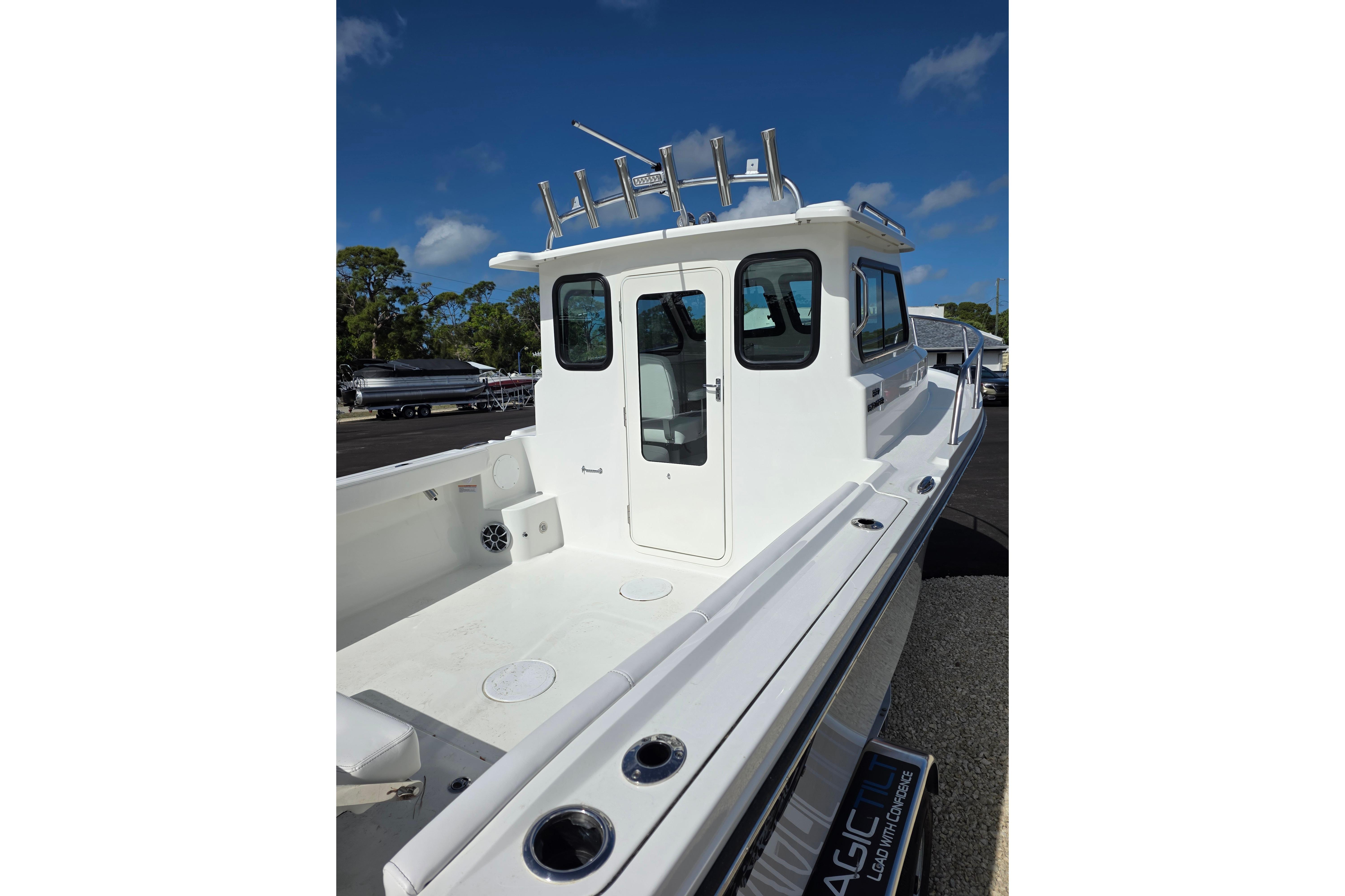 2026 Parker 227 Explorer boat with spacious deck and cabin, under clear blue sky.