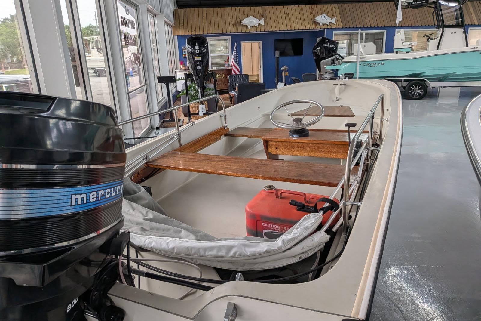 1978 Boston Whaler 15 SPORT boat with Mercury engine displayed indoors.