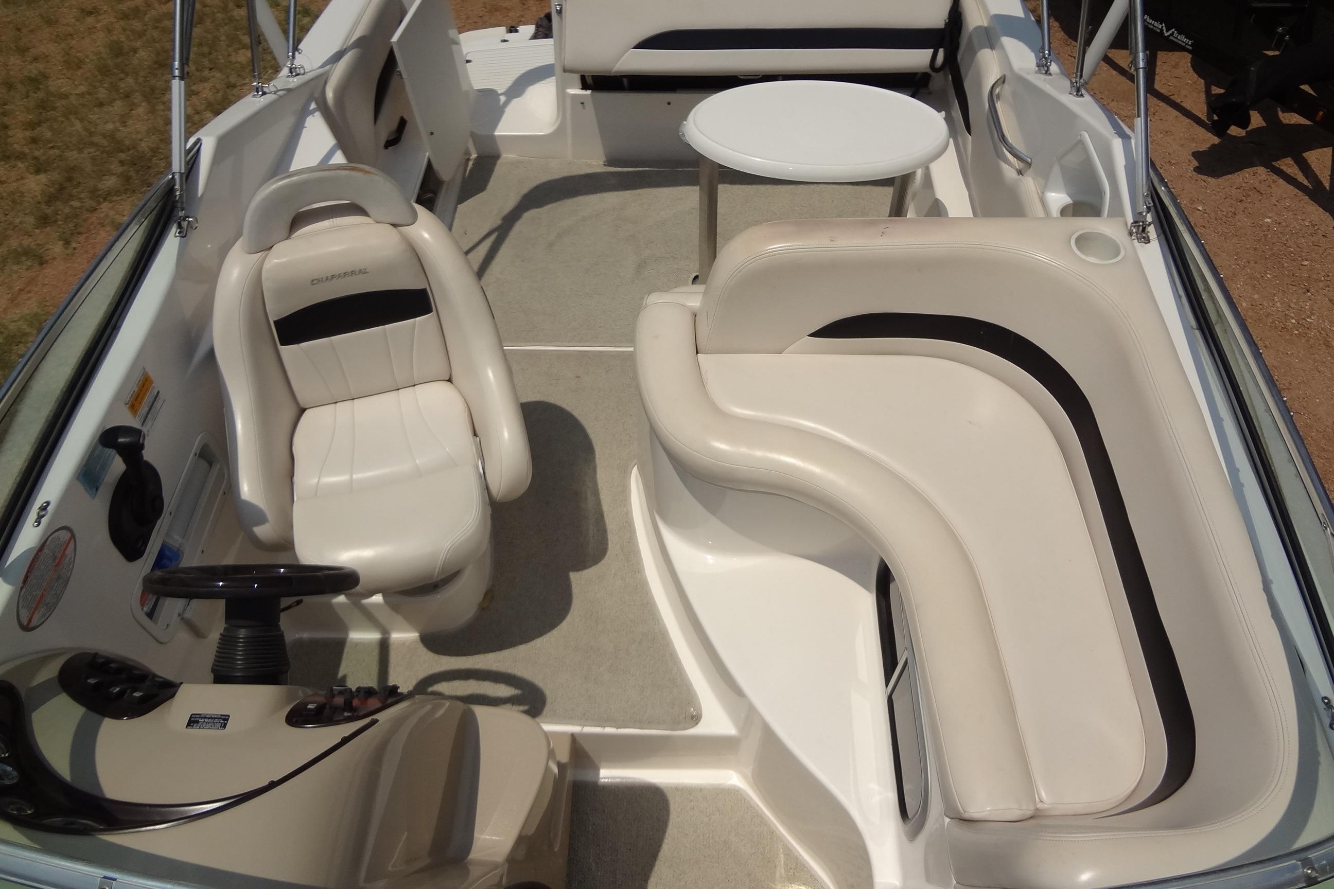 2000 Chaparral Signature 260 boat interior with white seating and steering wheel.