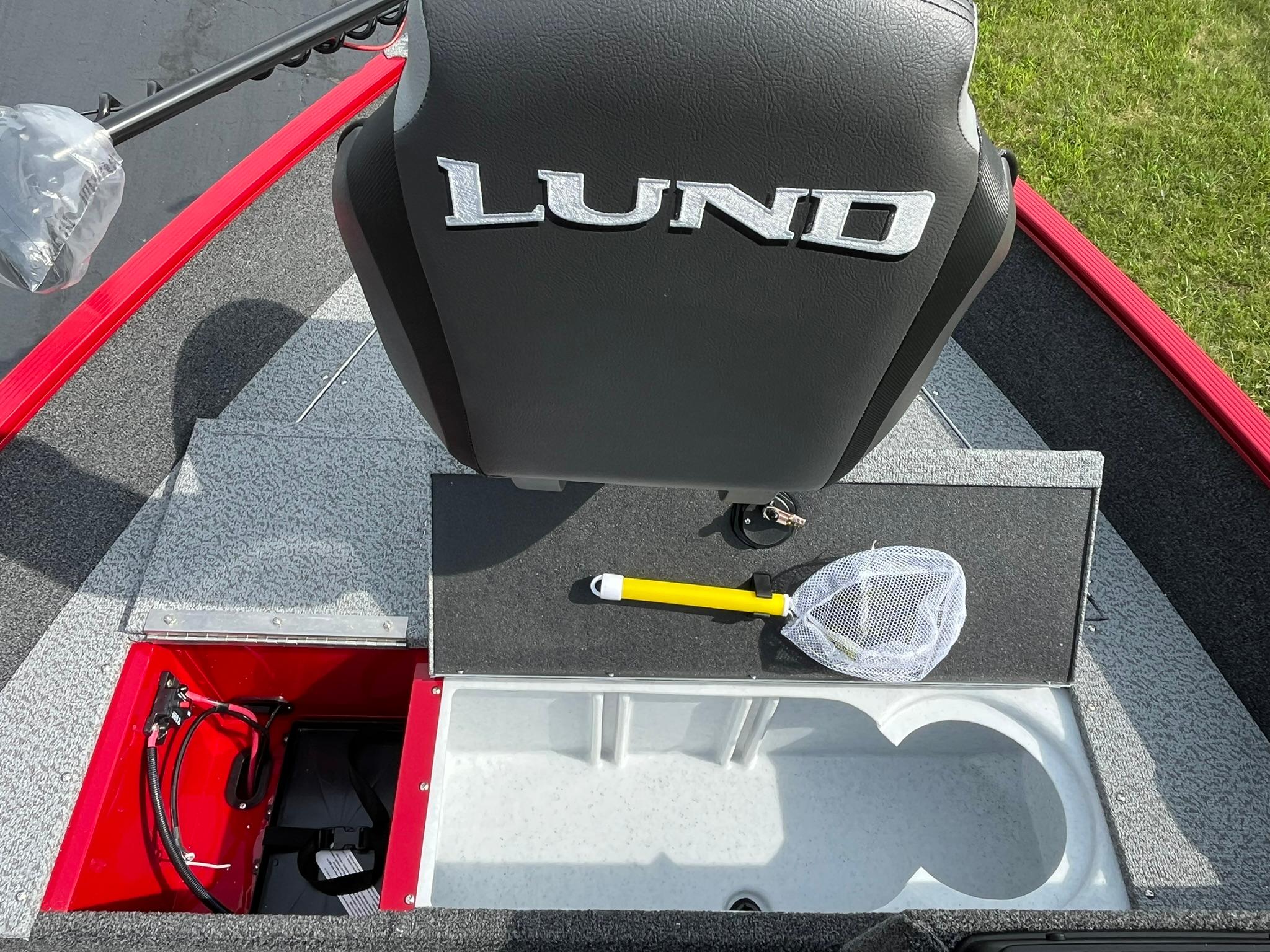 2026 Lund 1650 Angler SS boat interior with storage compartments and fishing net.