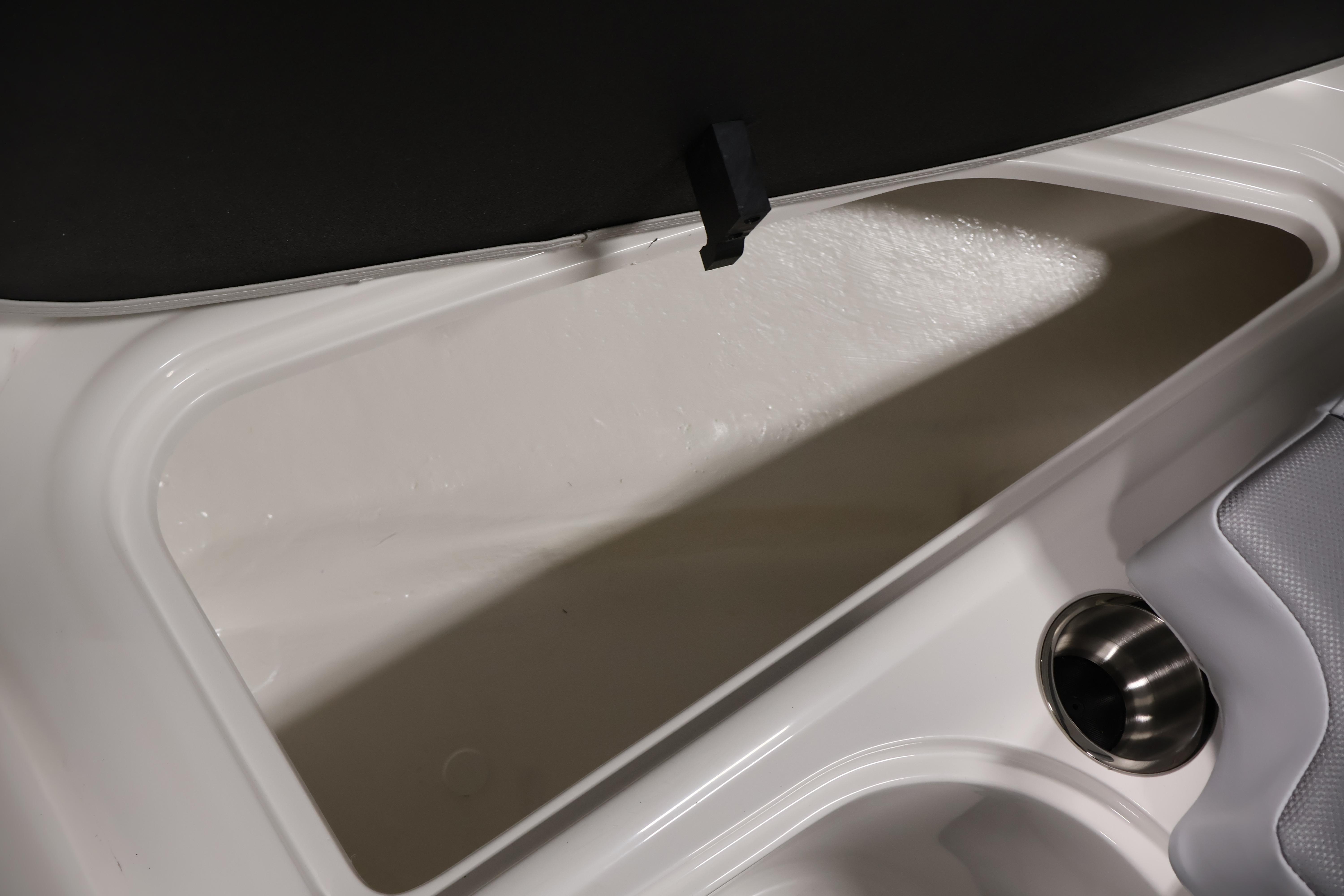2026 Bayliner VR6 Bowrider I/O storage compartment with cup holder detail.