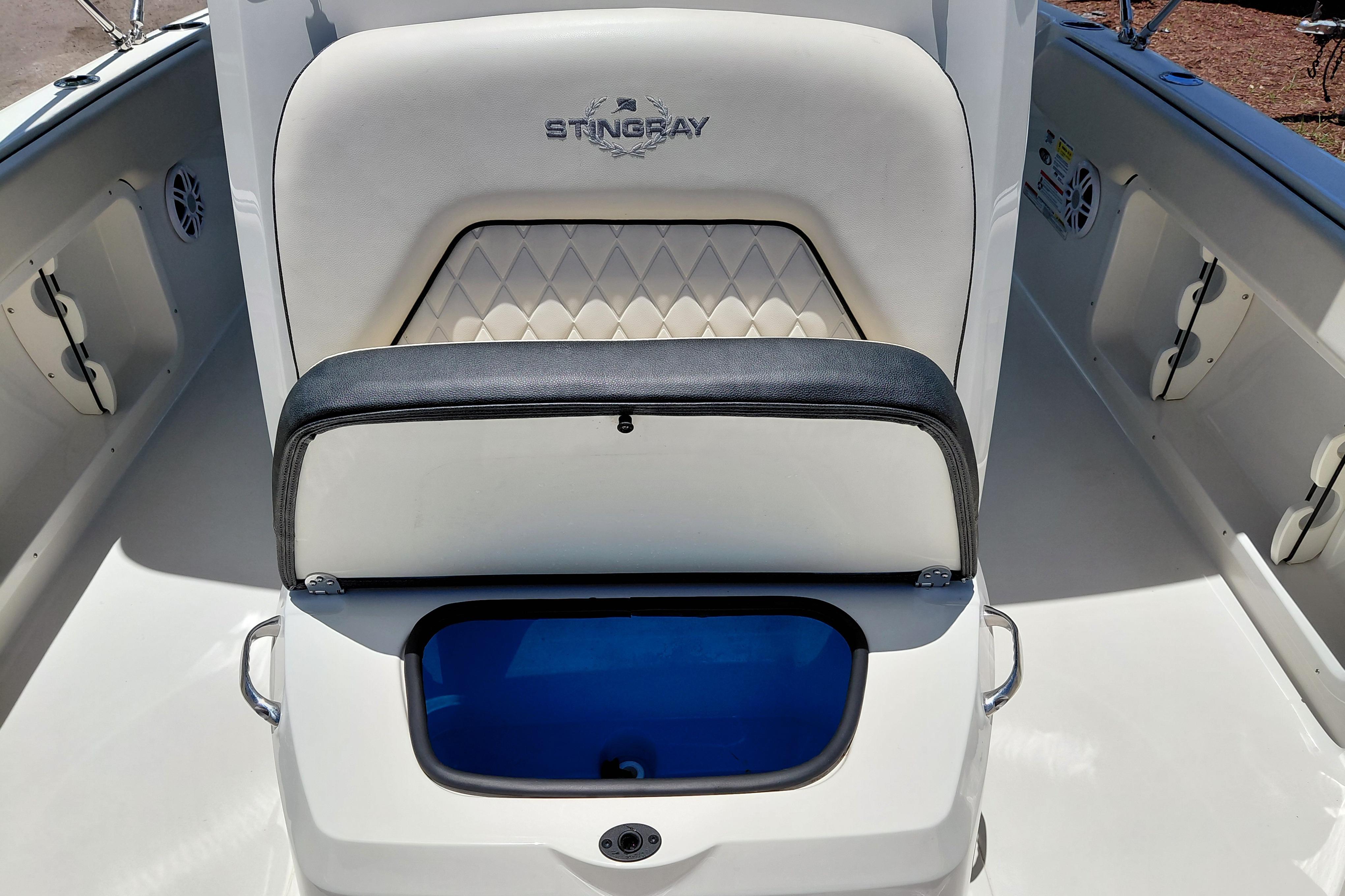2023 Stingray 206 CC boat interior with cushioned seating and storage compartment.