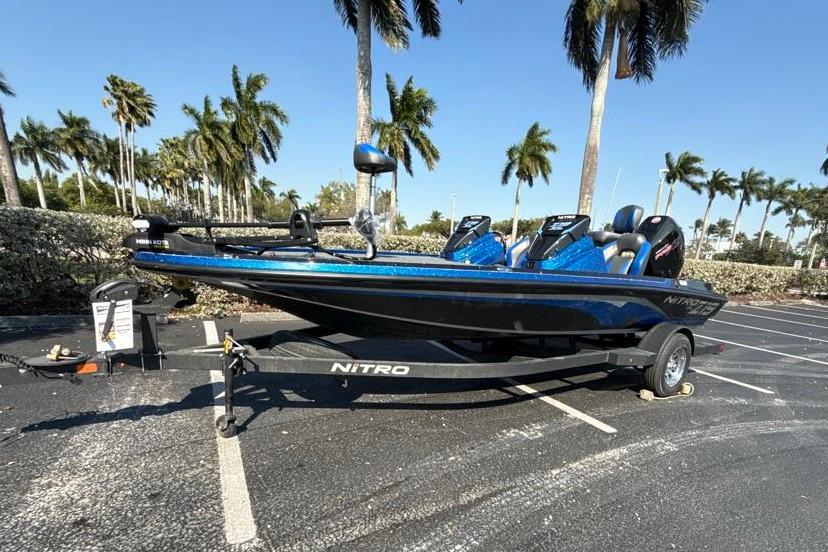 2026 Nitro Z19 XL boat on trailer, parked under palm trees.