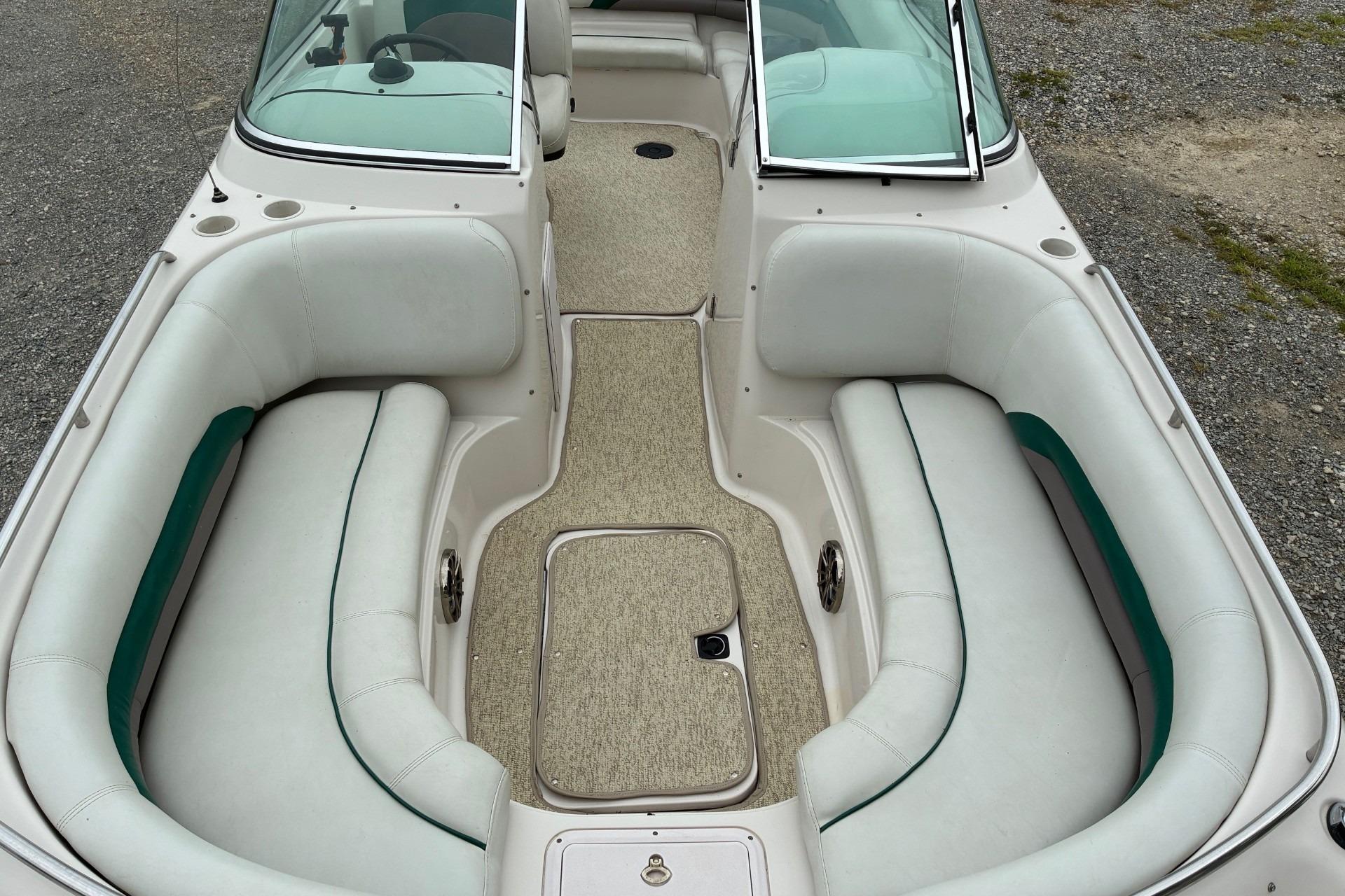 2003 Hurricane 234 SD boat interior with white seating and green accents.