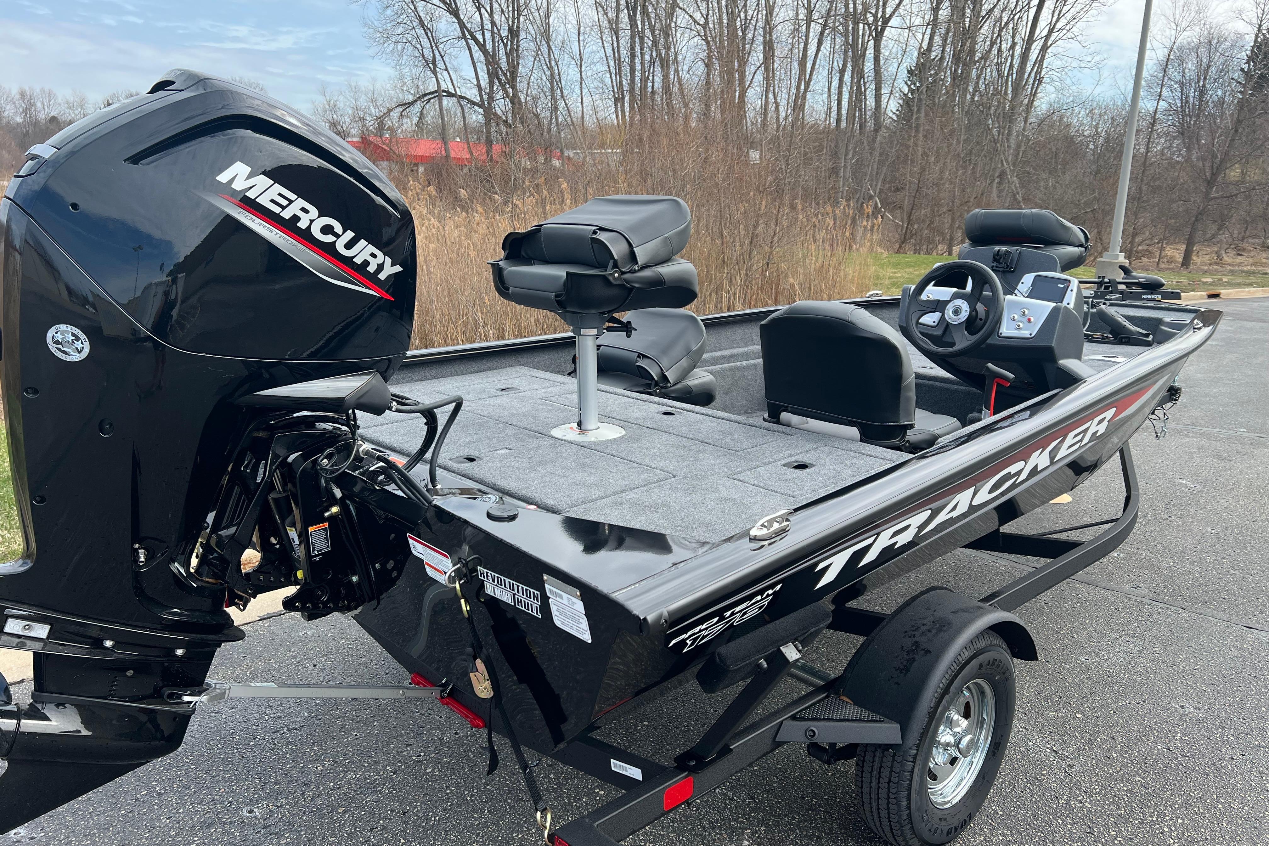 2026 Tracker Pro Team 175 Crappie Edition boat with Mercury engine, parked outdoors.