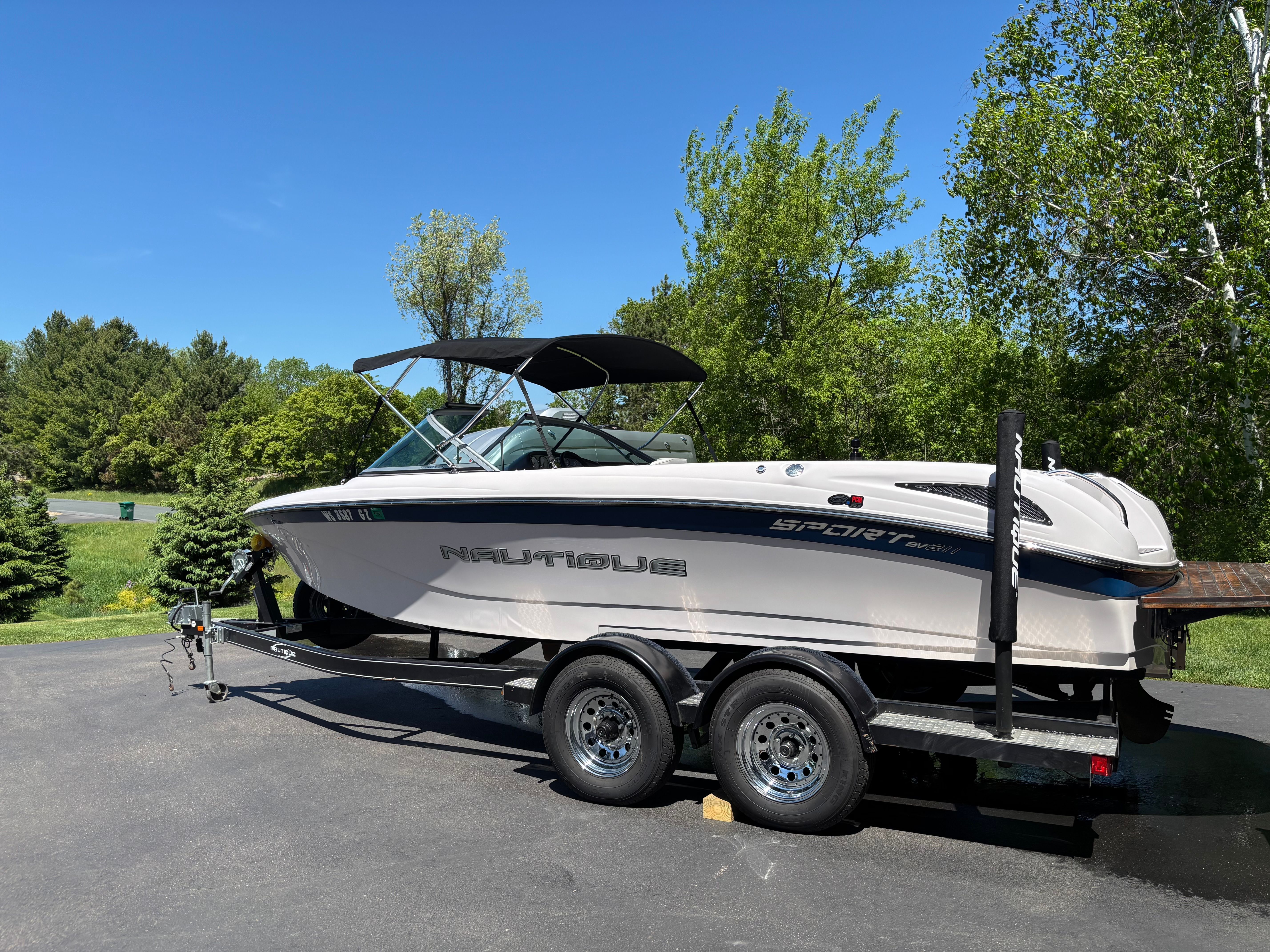 2005 Nautique Sport SV-211 boat on trailer outdoors.
