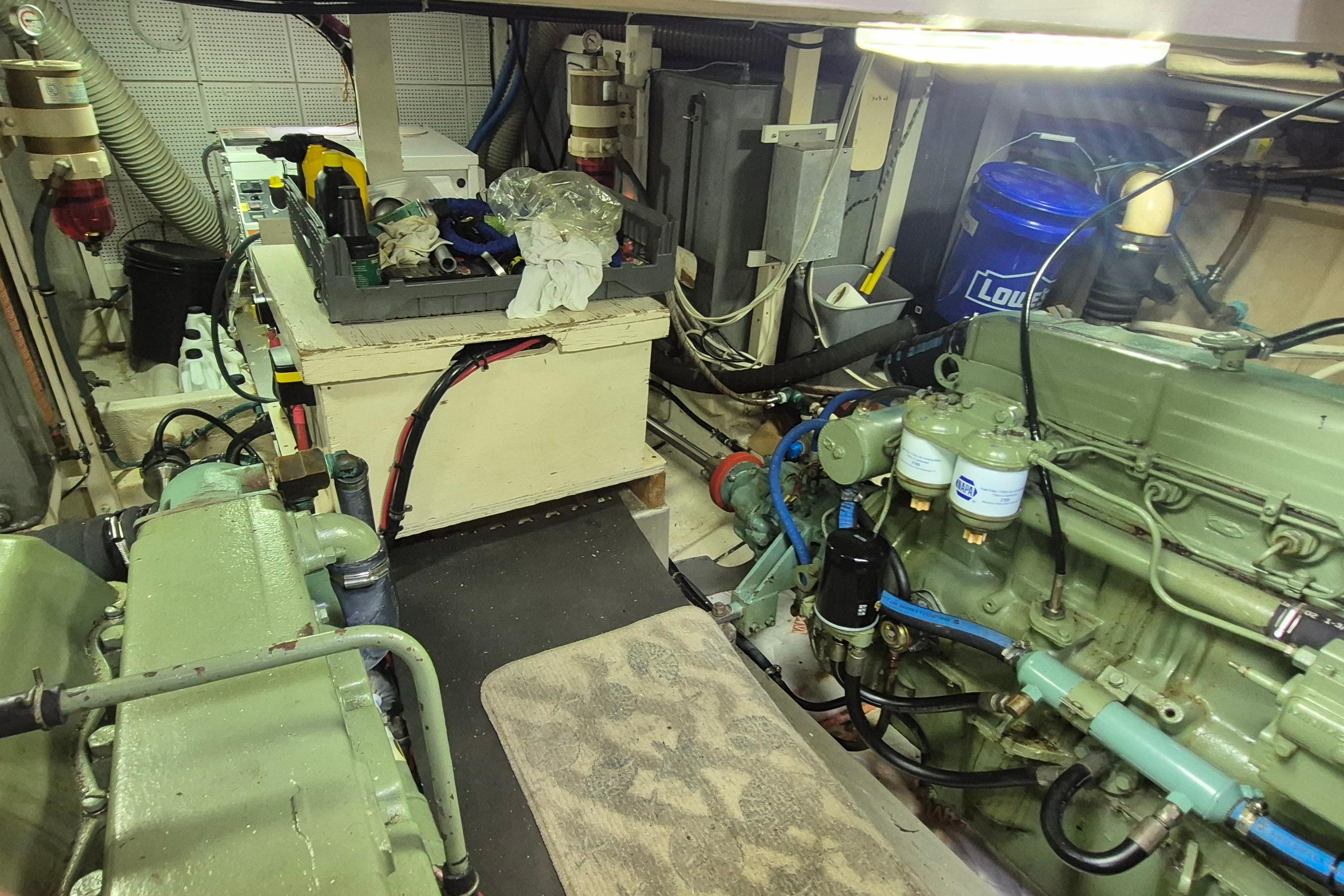 Engine room of a 1983 Grand Banks 42 Motoryacht with visible machinery and tools.