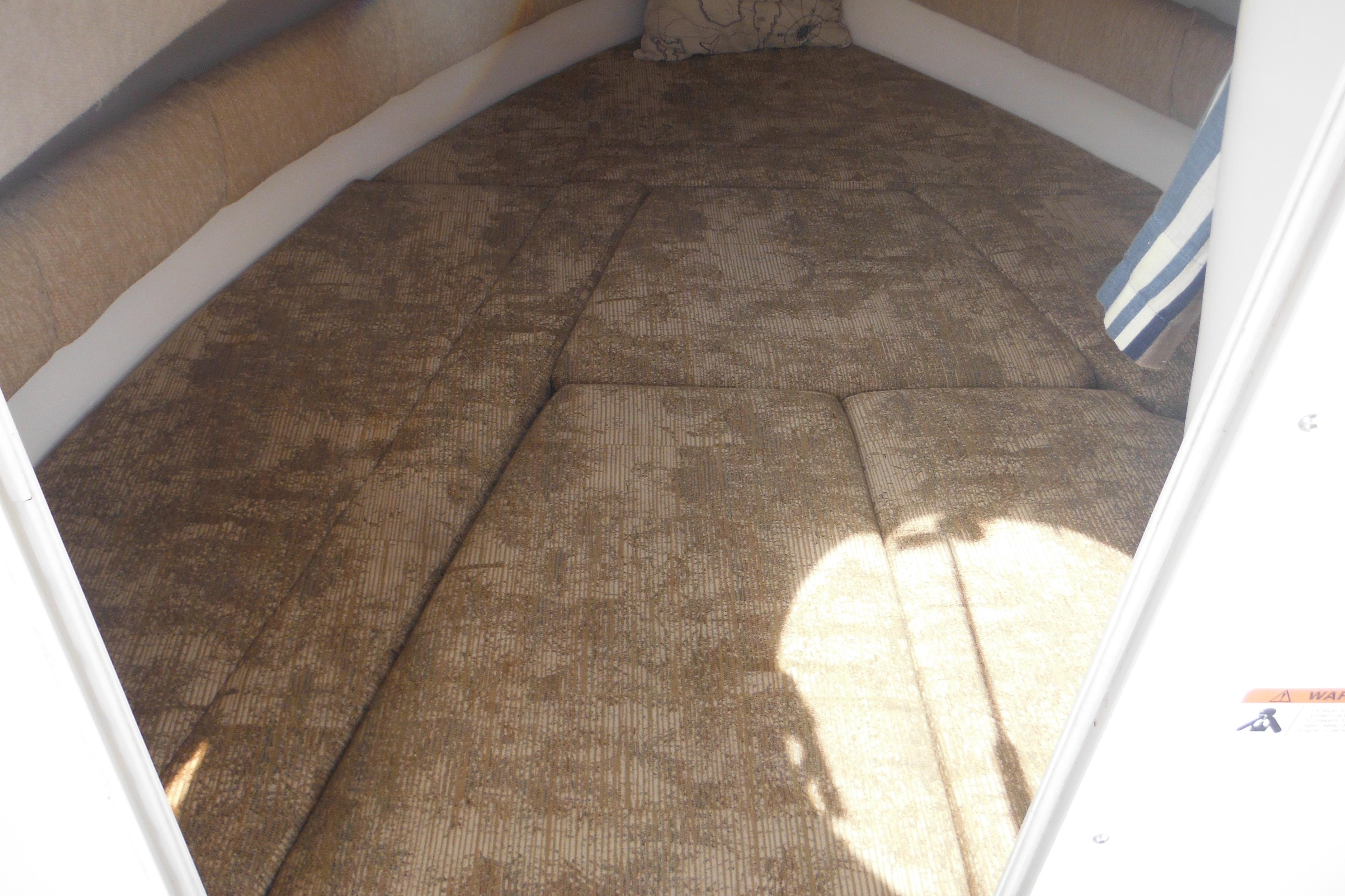Interior cabin of 2005 Seaswirl Striper 2101 Walkaround O/B with cushioned seating.