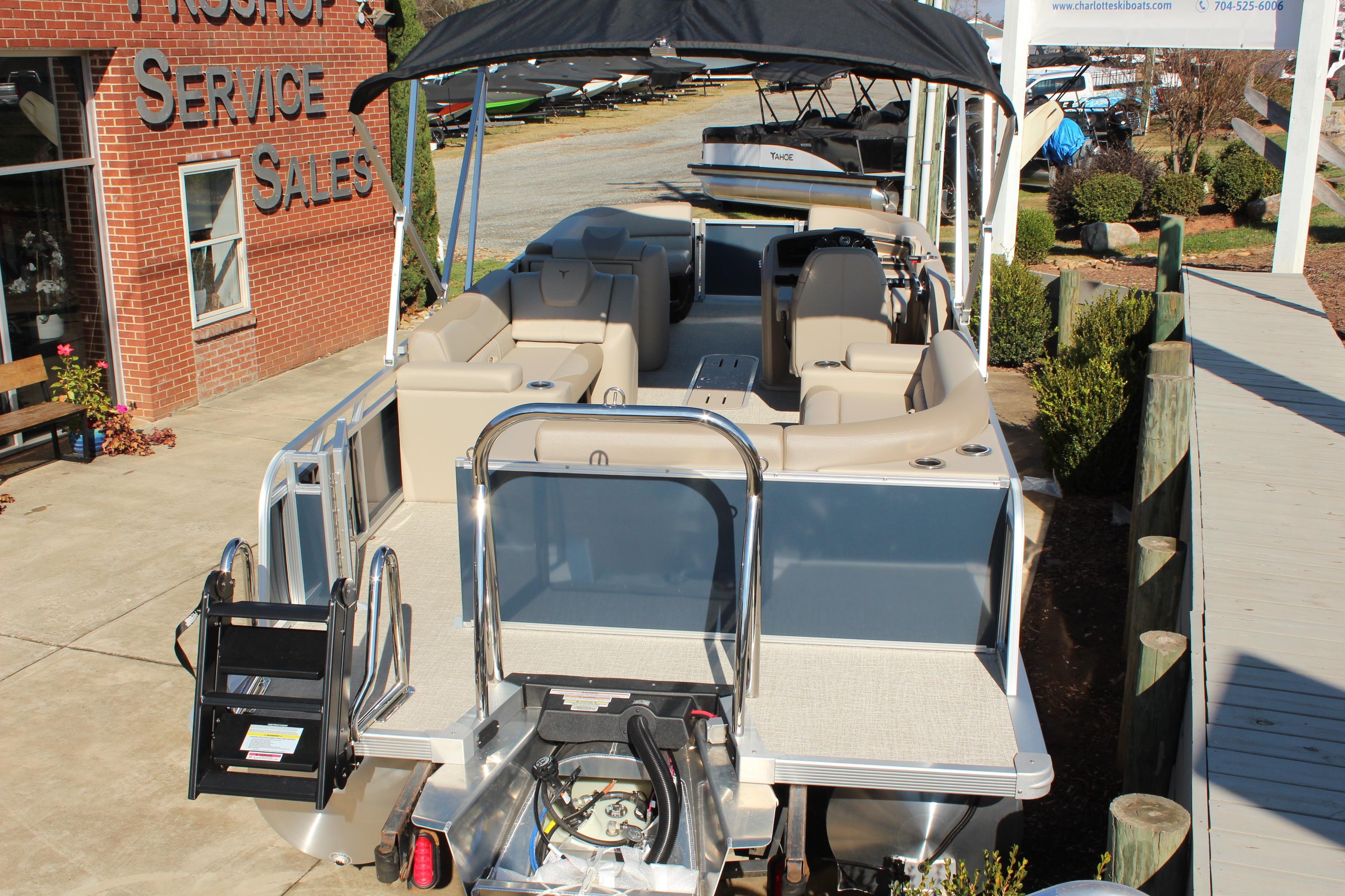 2026 Tahoe Pontoon LTZ Elite at dealership, showcasing luxury seating and sleek design.