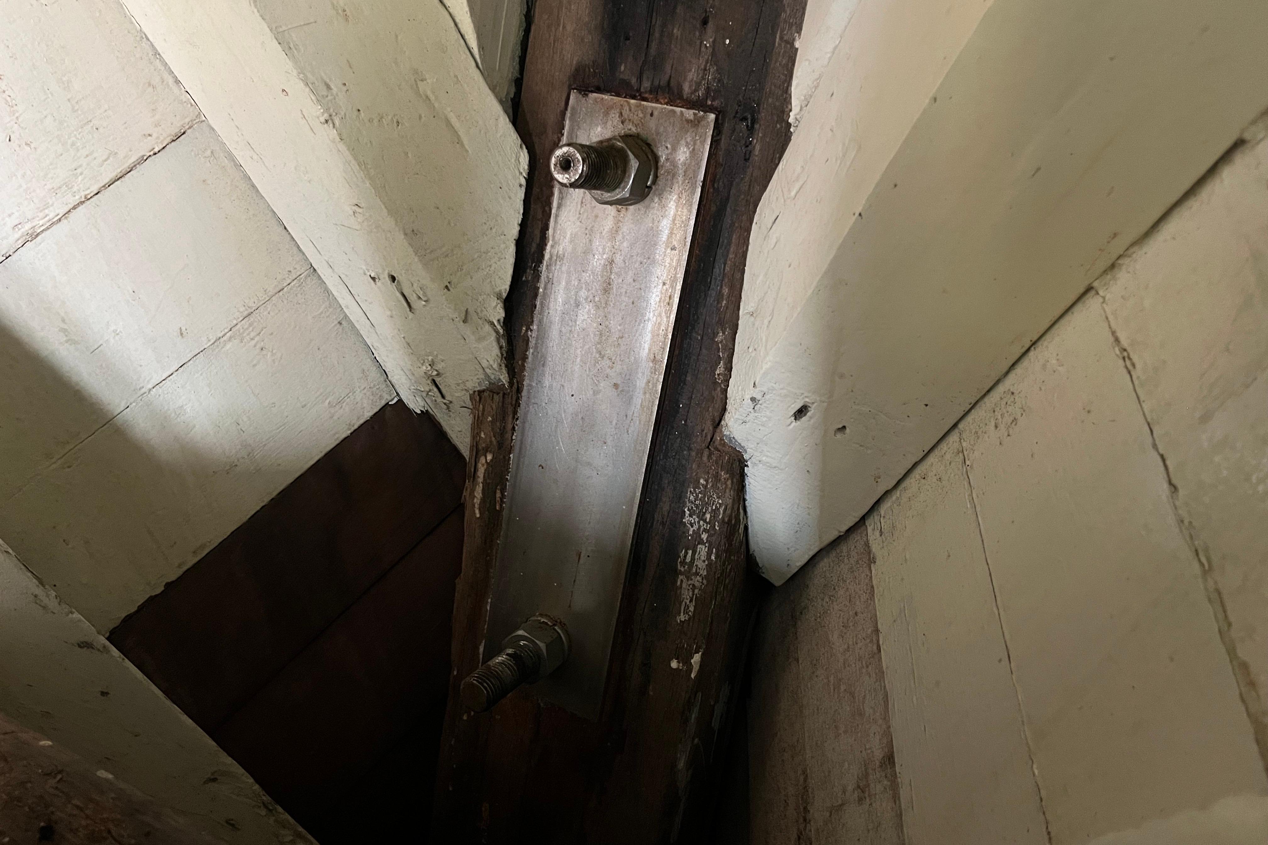 Close-up of 1947 Murray Peterson Schooner's wooden interior structure with metal bolts.