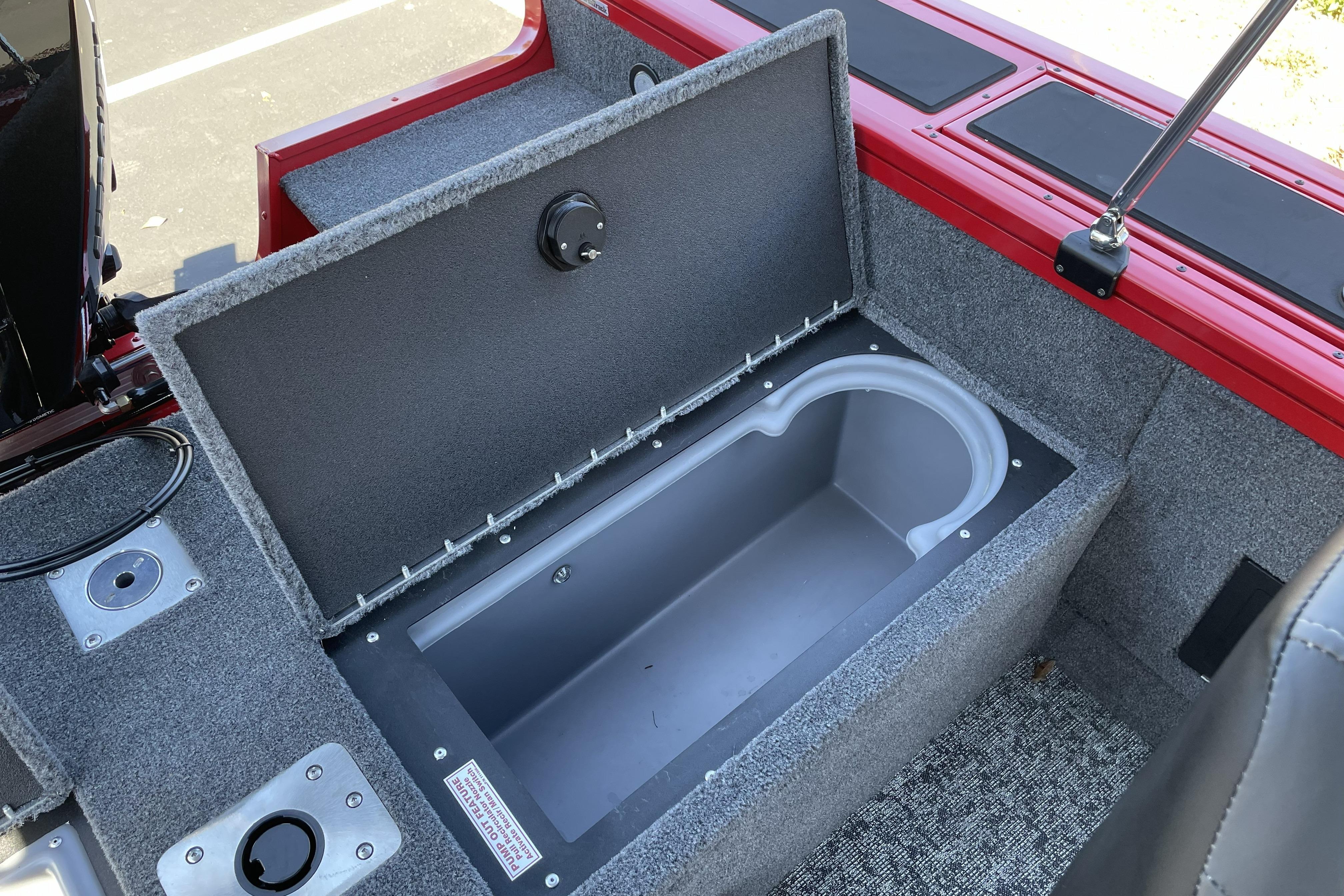 2026 Tracker Targa V-18 WT boat storage compartment with open lid, showcasing interior space.