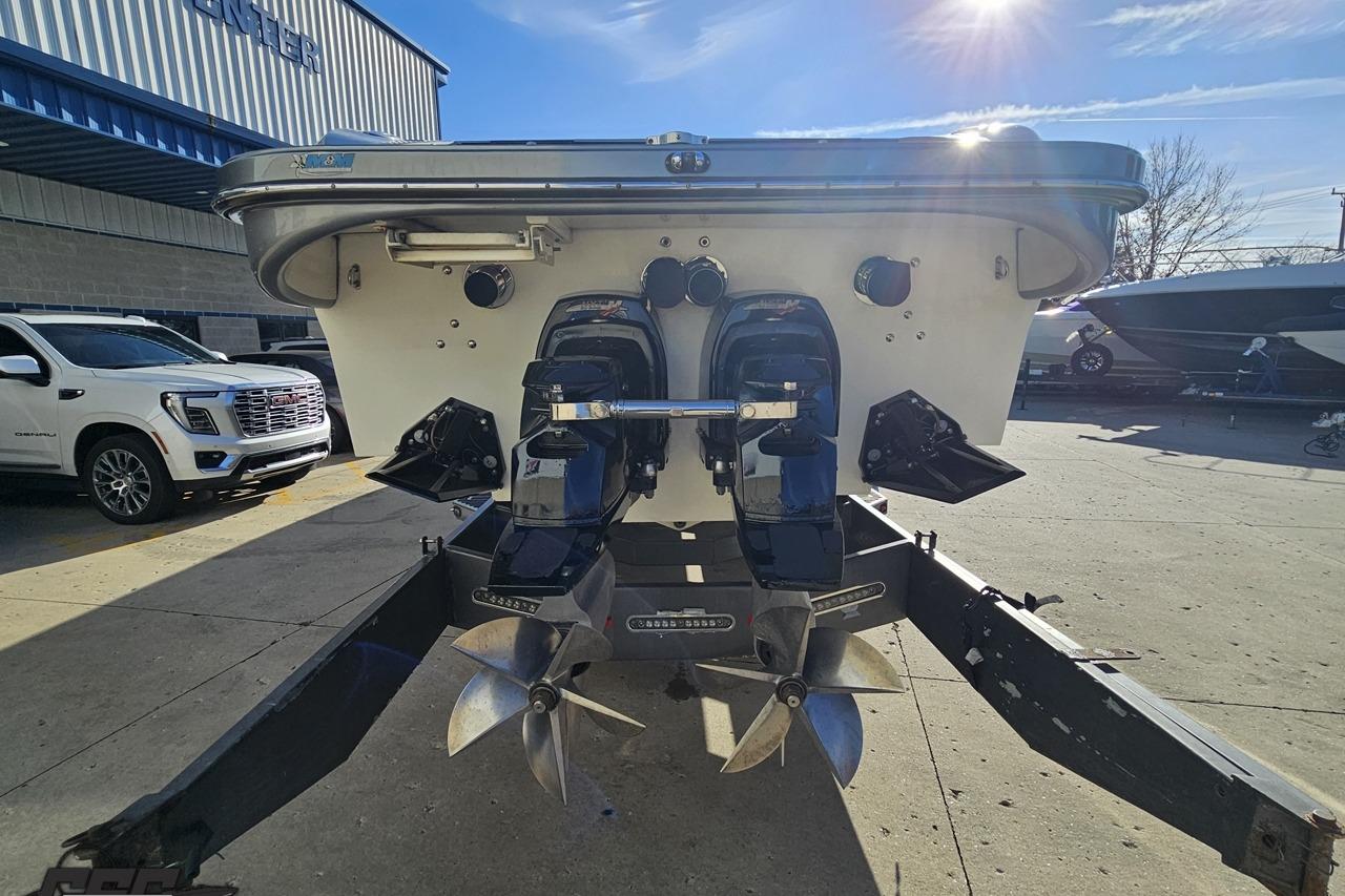 2007 Hustler 41 Razor boat with dual outboard motors in a sunny marina setting.