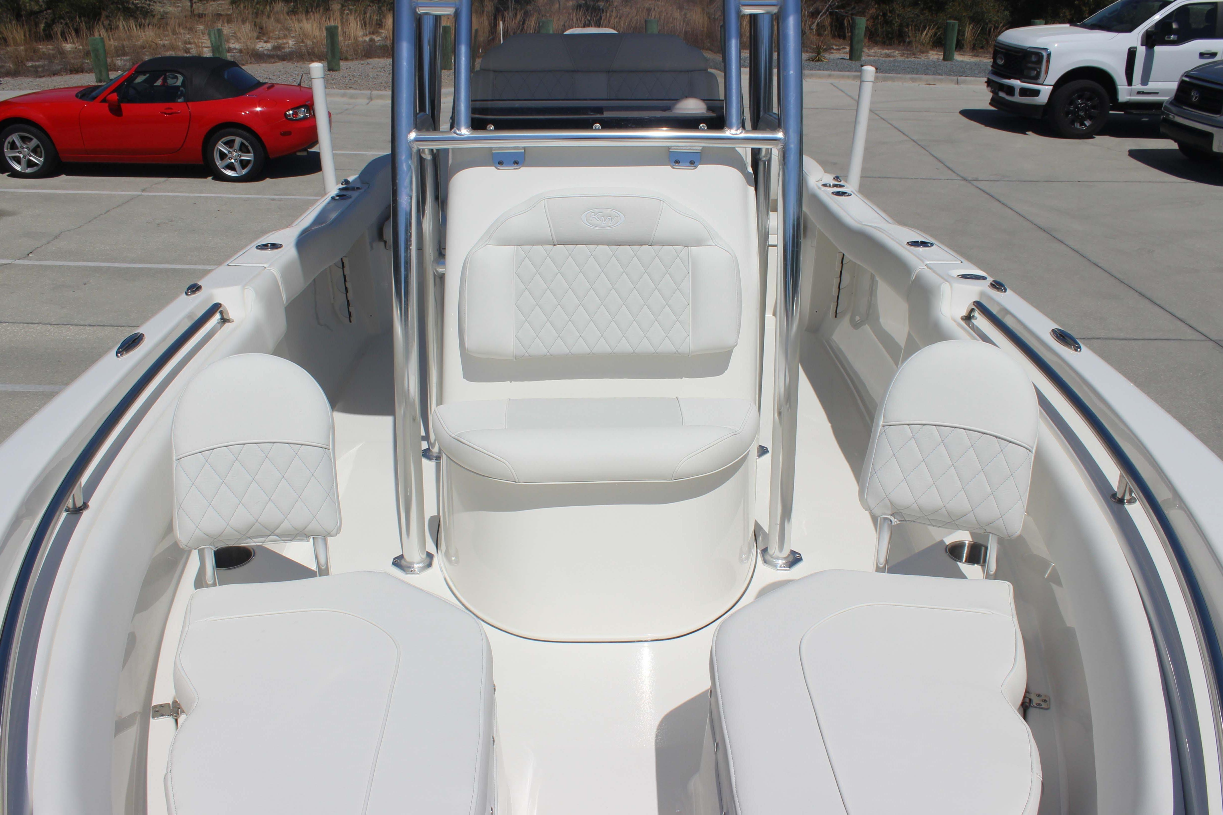 2026 Key West 203 FS boat interior with white seating and chrome accents.