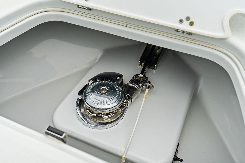Anchor locker of 2021 Yellowfin 36 Offshore boat, featuring a polished winch system.