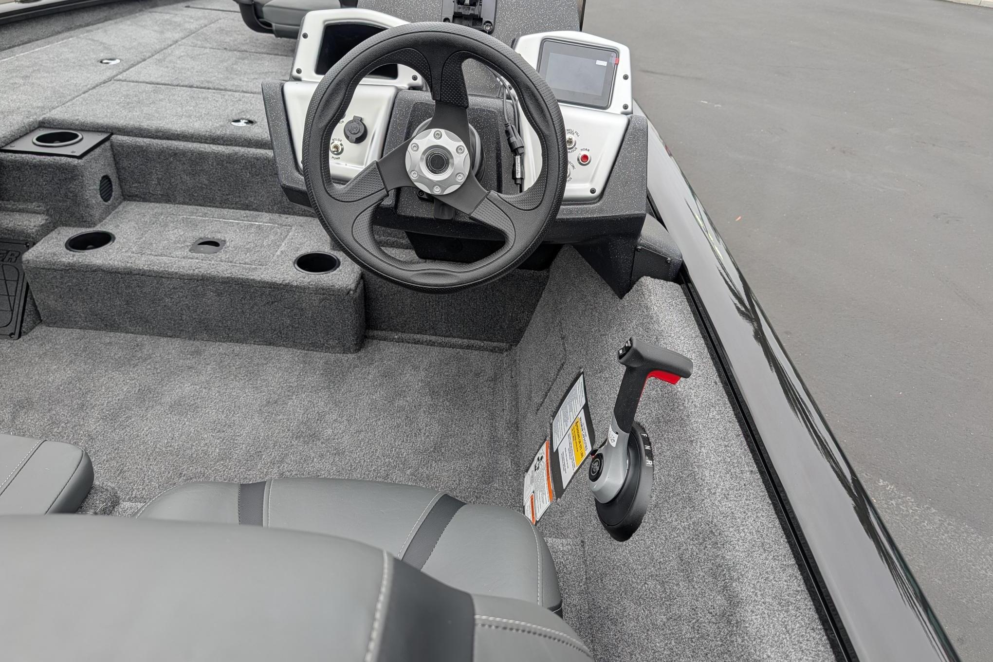 2026 Tracker Pro Team 195 boat interior with steering wheel and control panel.