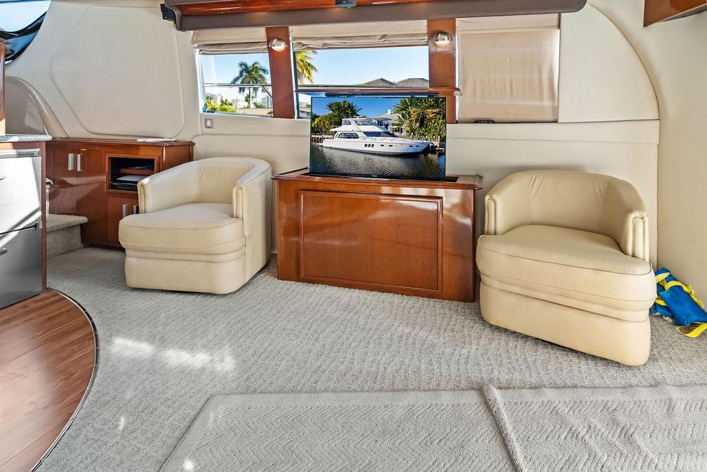 Luxurious interior of 2009 Carver 56 Voyager SE yacht with plush seating and elegant decor.