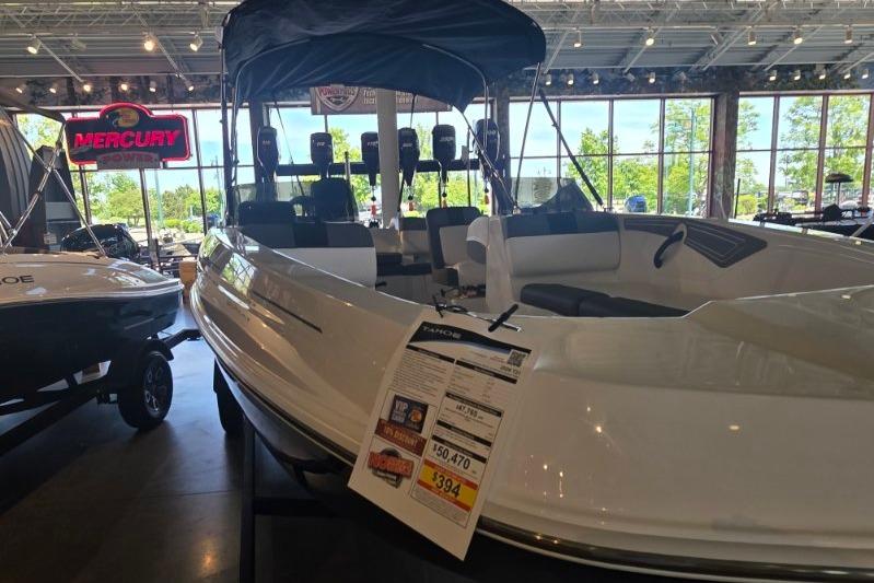 2026 Tahoe T21 boat displayed in showroom with price tag and Mercury sign.