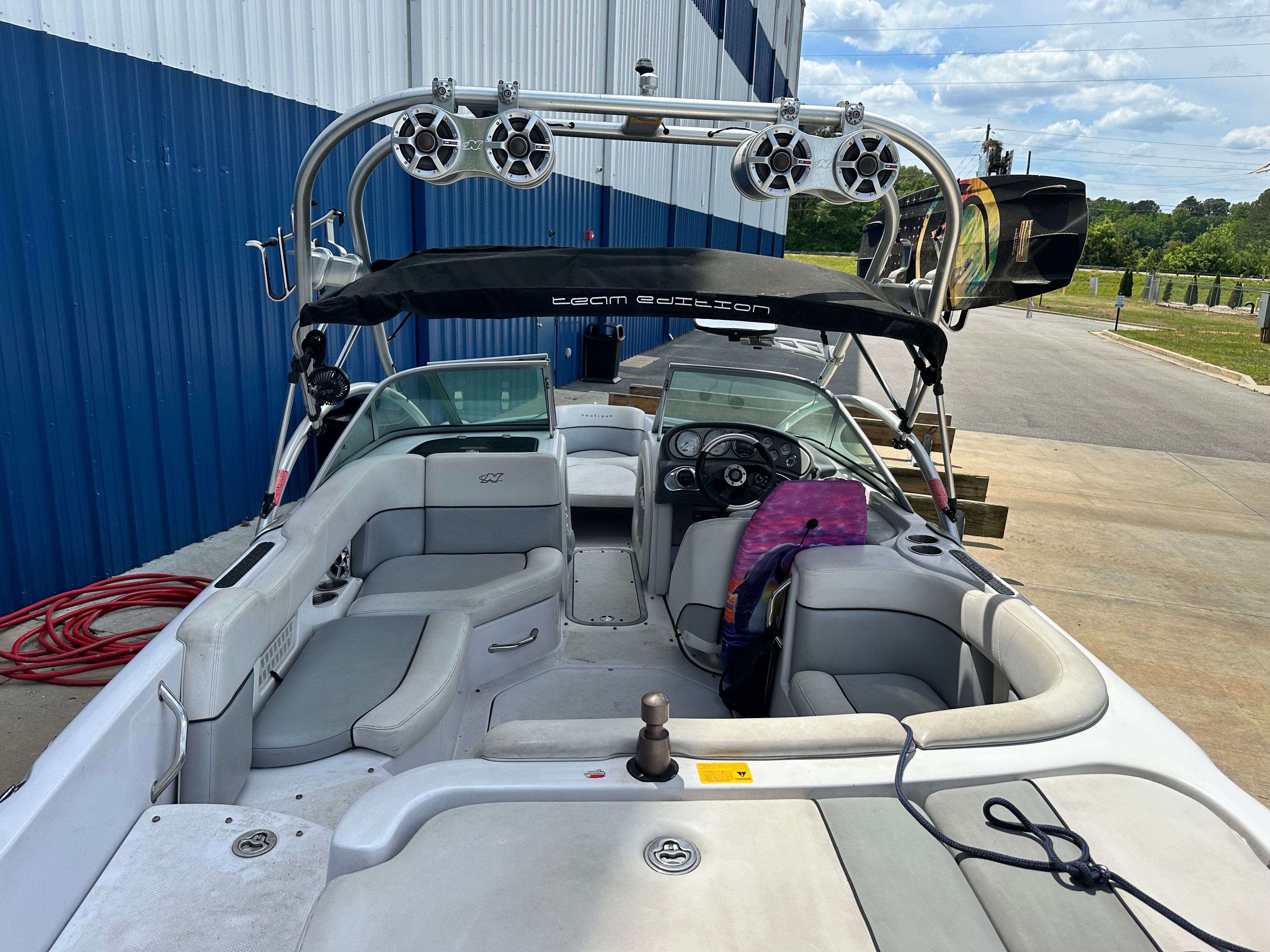 Interior view of a 2007 Nautique SV 211 with gray seating and a black Bimini top.
