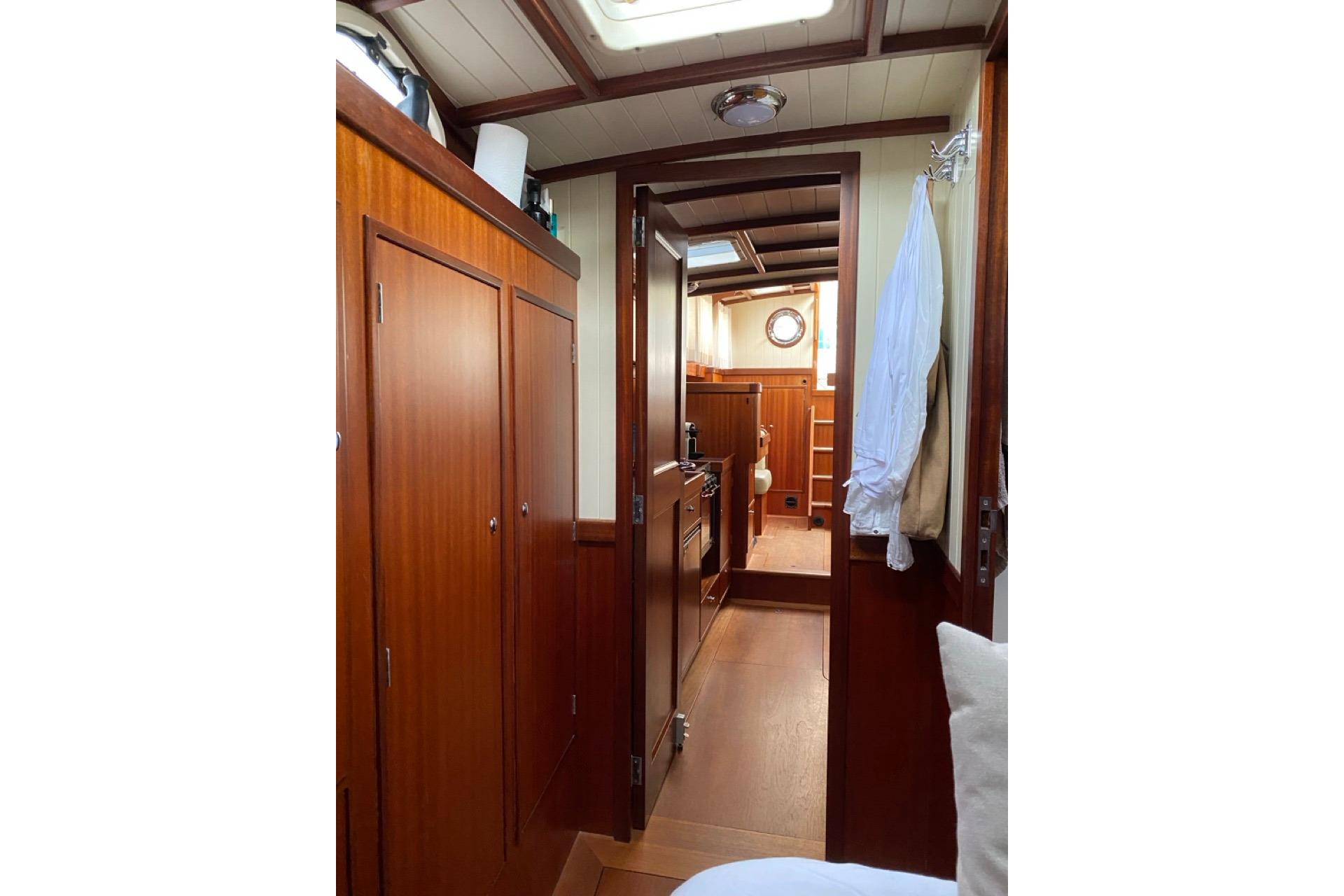 Interior of 2008 Puffin 41 yacht, featuring wooden cabinetry and cozy living space.